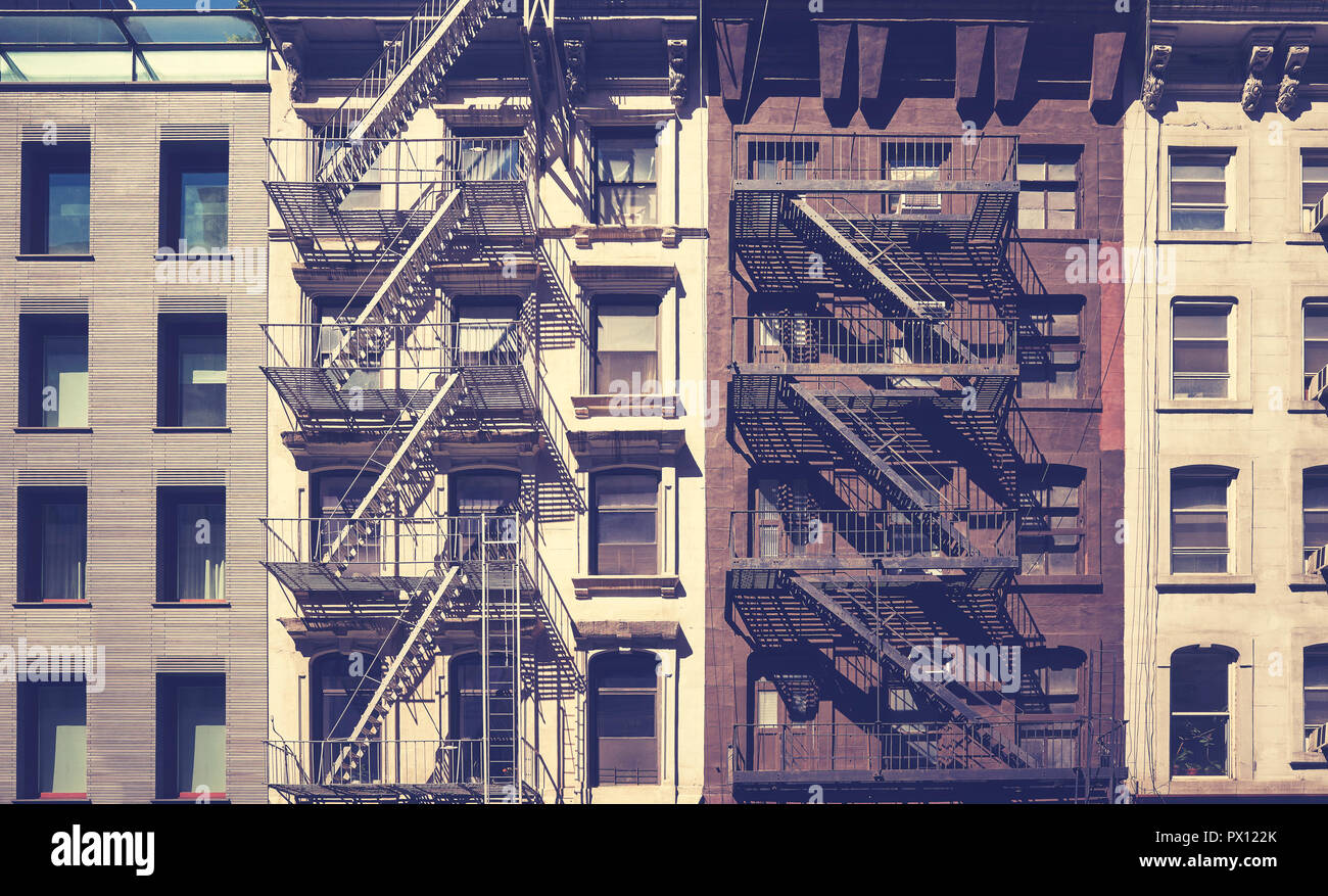 Old buildings with fire escapes, vintage toning applied, New York City ...