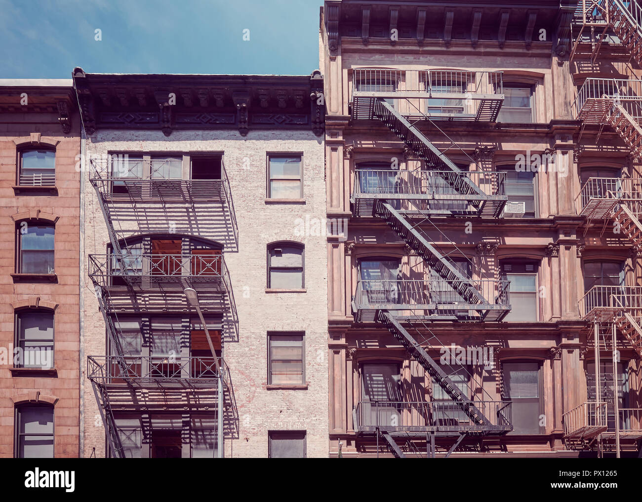 Old buildings with fire escapes, one of the New York City symbols ...