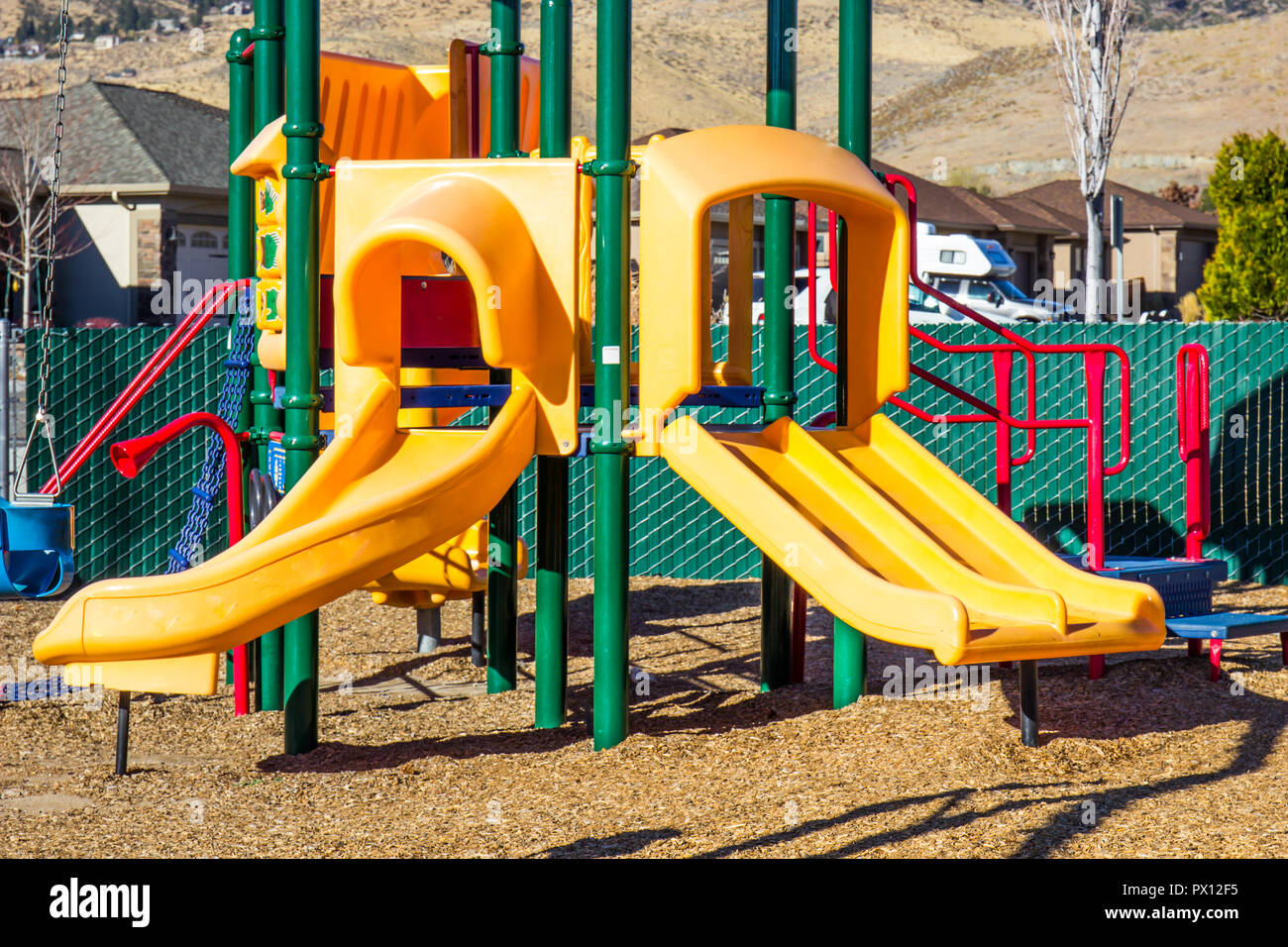 Yellow Slides On Children's Playground Equipment Stock Photo Alamy