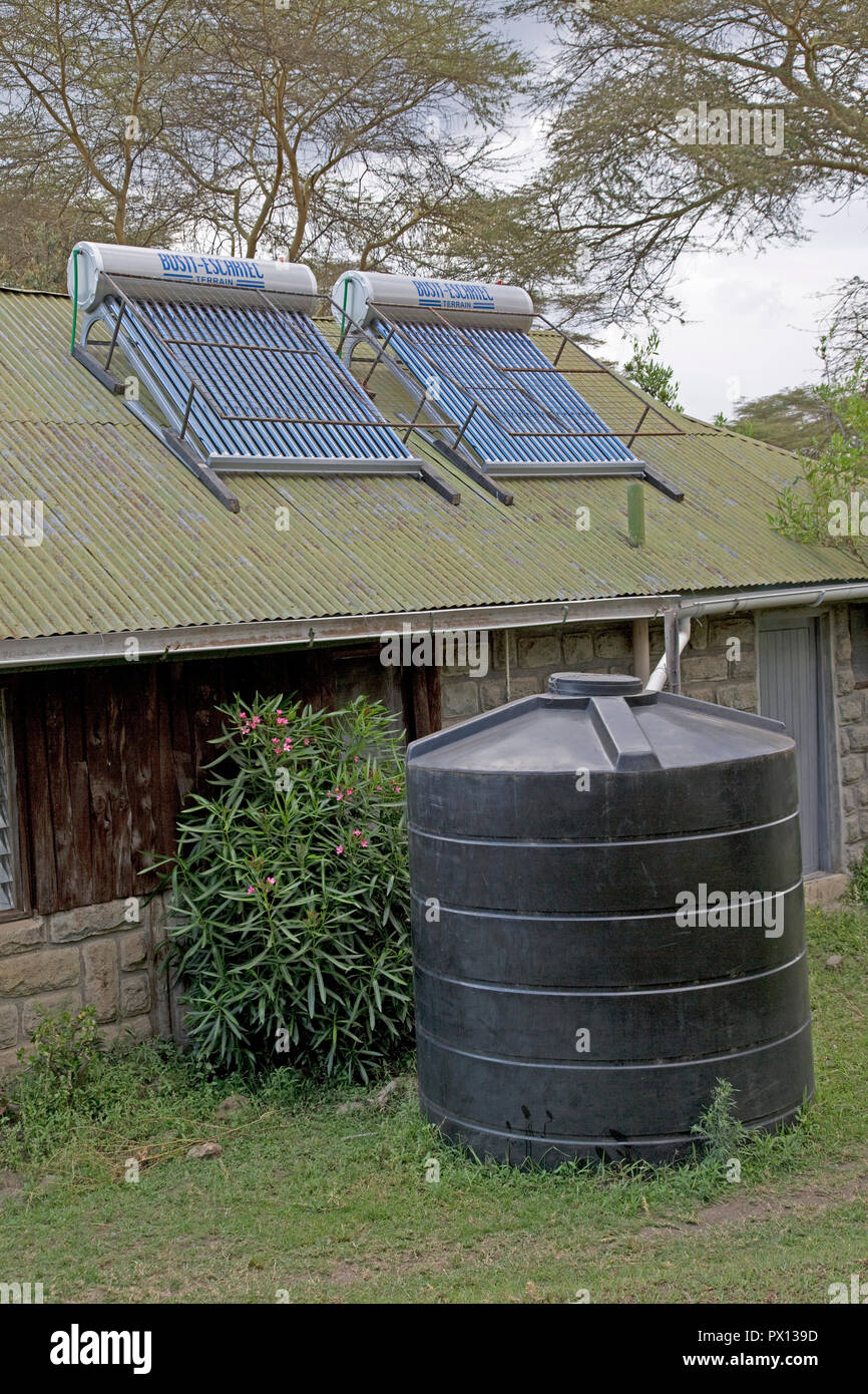 Solar thermal hot water system with storage tank on roof of guest cottage Elsamere Kenya Stock Photo