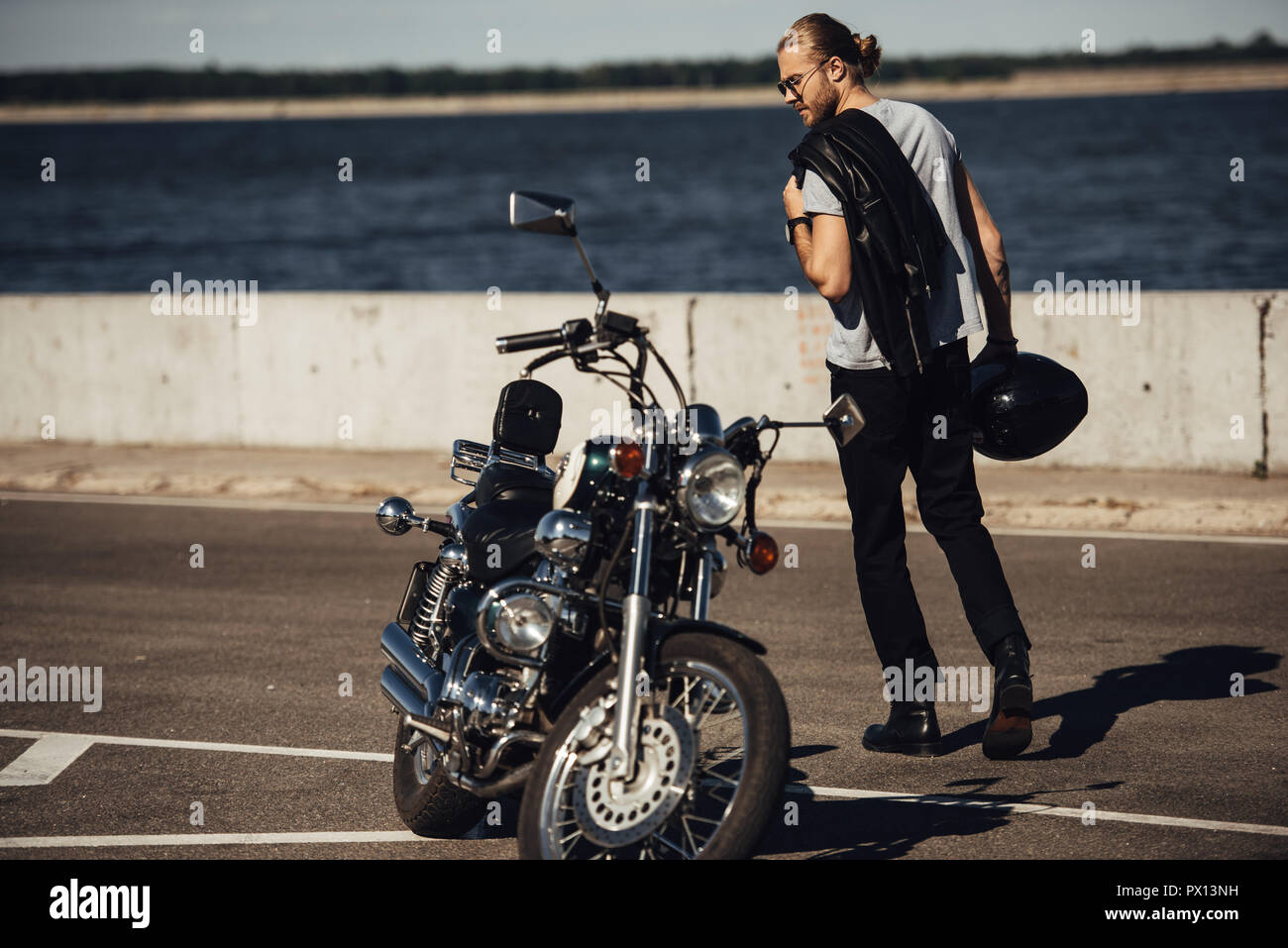 young biker with chopper motorcycle in city with river Stock Photo - Alamy