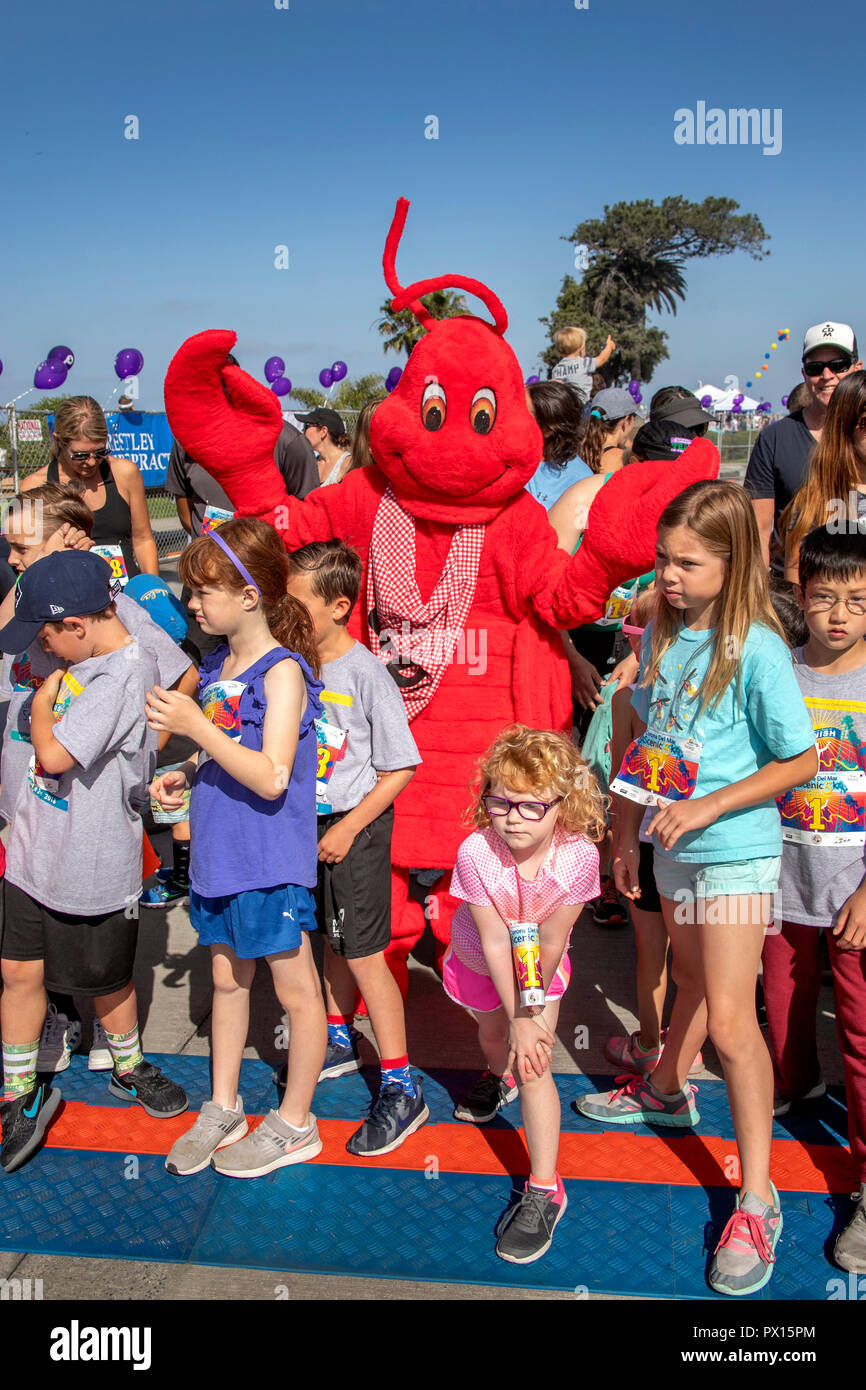 A man in a lobster costume entertains multiracial children at the