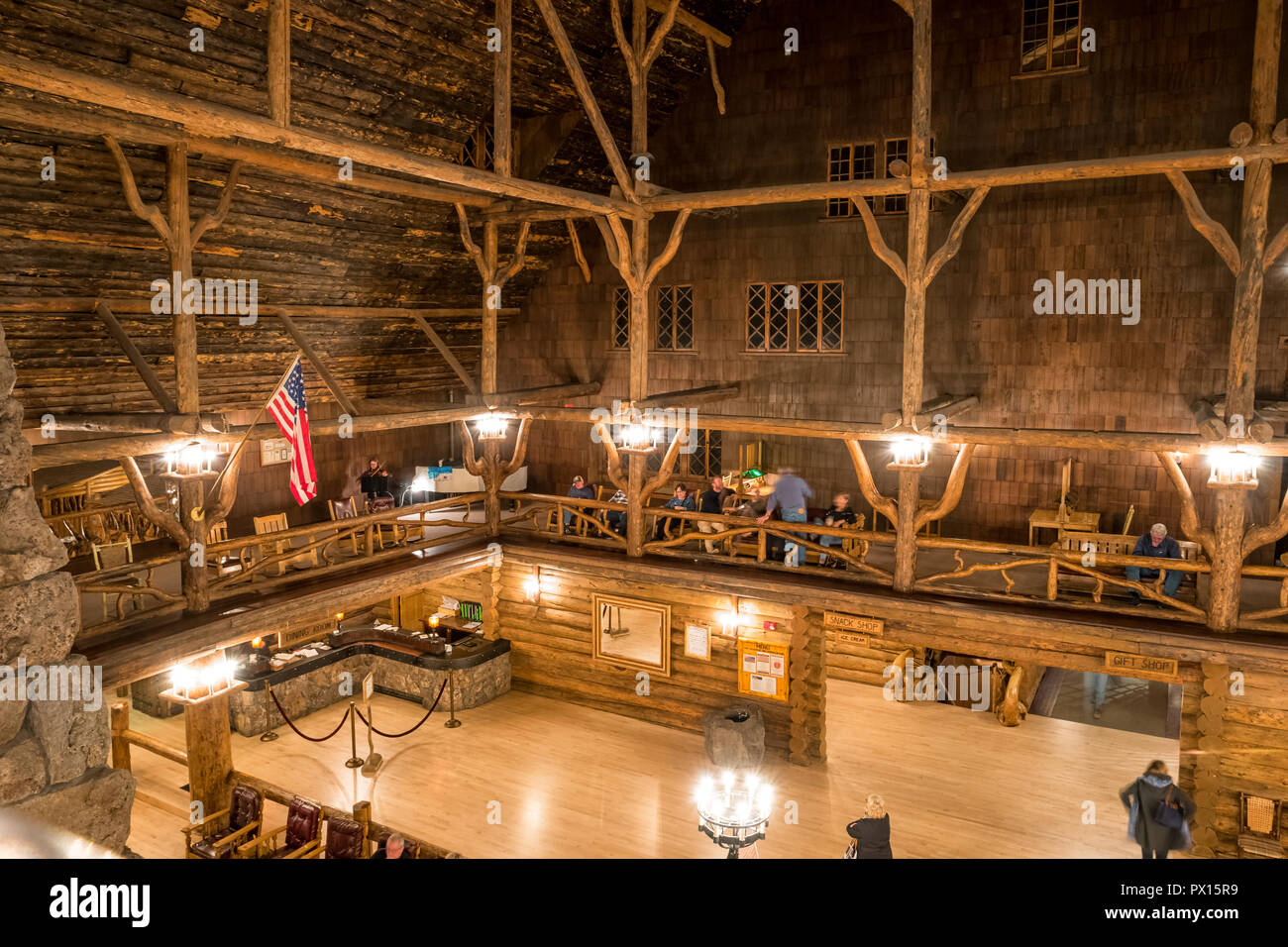 People relax in the atrium of the Old Faithful Inn in Yellowstone National Park, Wyoming, USA Stock Photo
