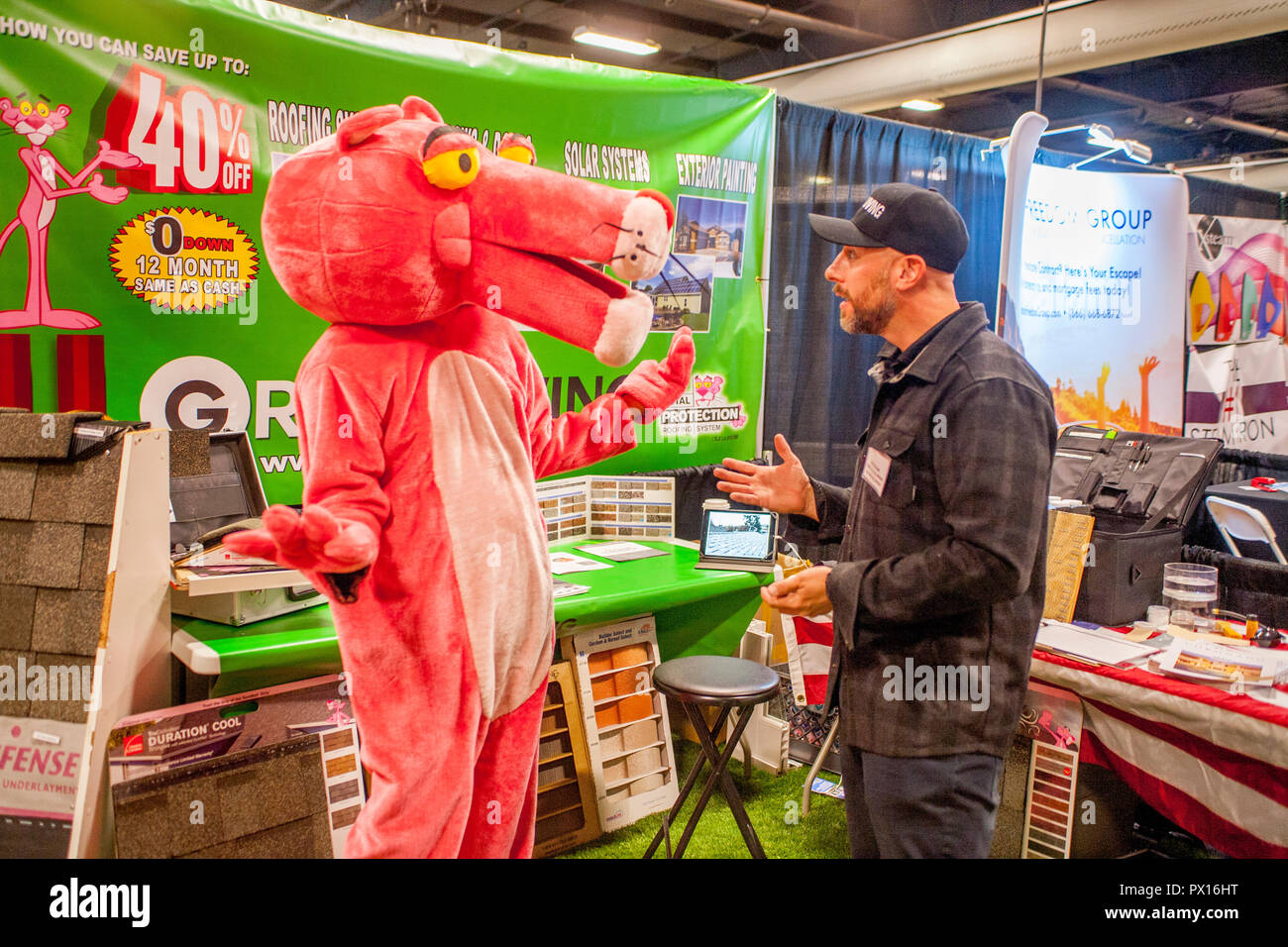 A costumed Pink Panther livens up a contractor's display at a home improvement exhibition in Costa Mesa, CA Stock Photo