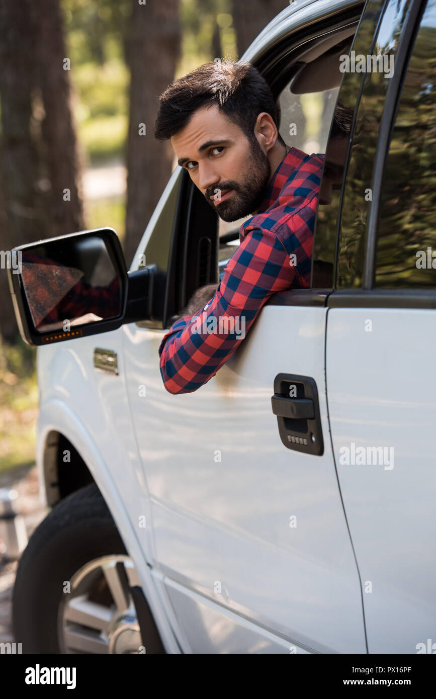 bearded driver in white pickup truck looking at camera Stock Photo - Alamy