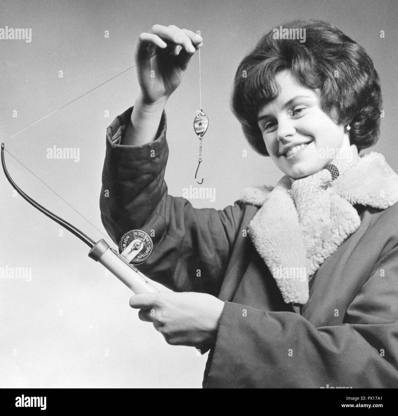 Fishing in the 1960s. A woman is holding an fishing rod and a fishing lure especially used when ice-fishing through a drilled hole in the ice. Sweden 1960s Stock Photo - Alamy Fishing in the 1960s. A woman is holding an fishing rod and a fishing lure especially used when ice-fishing through a drilled hole in the ice. Sweden 1960s Stock Photo - Alamy