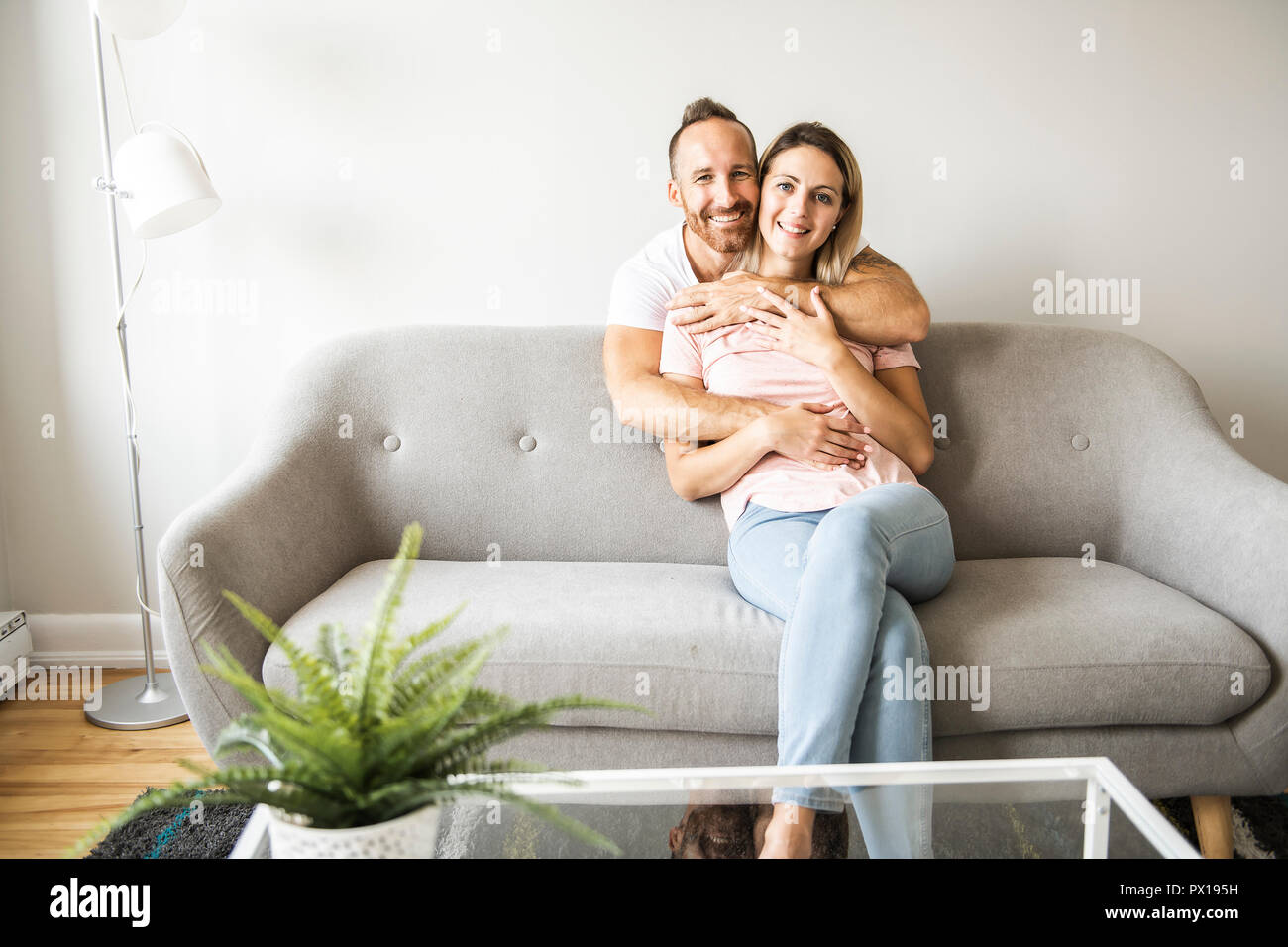 Young Couple On The Sofa Relaxing At Home Stock Photo 222534637