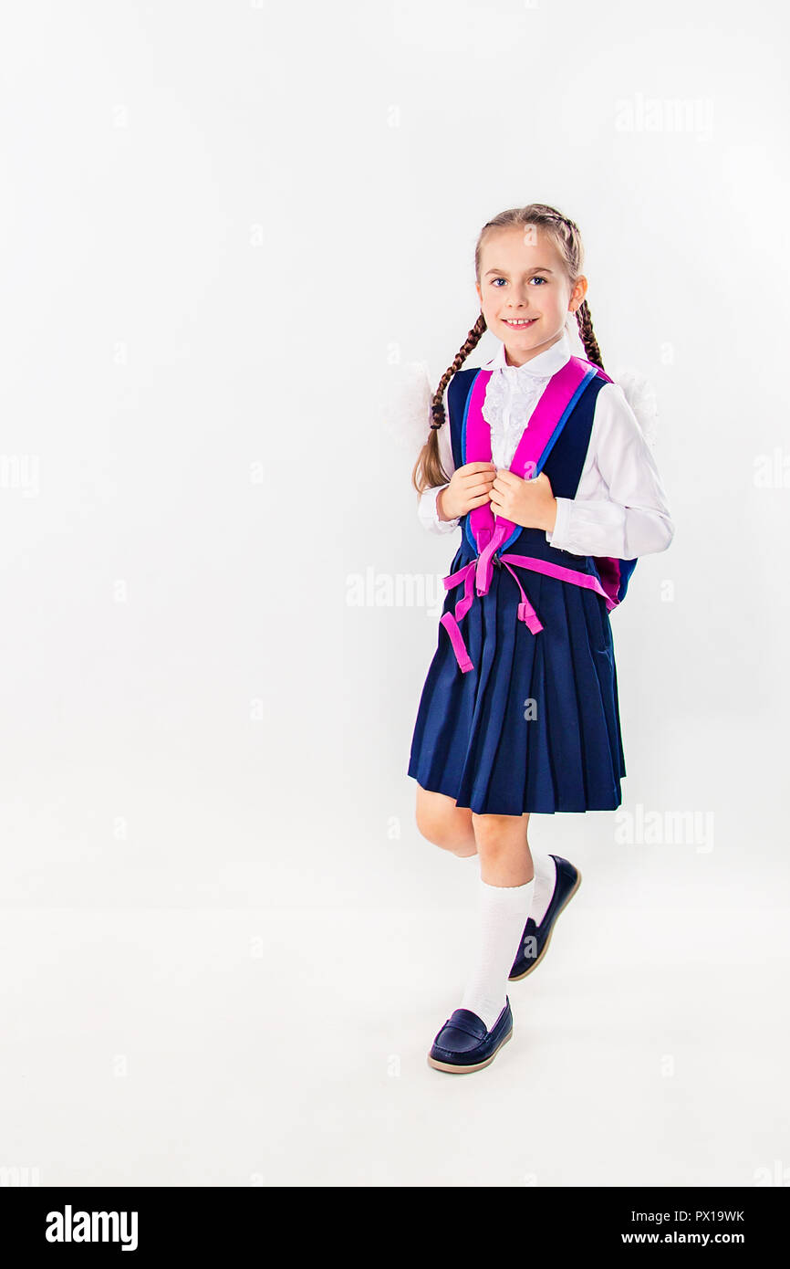 Cute schoolgirl with notebooks and books on a white background ...