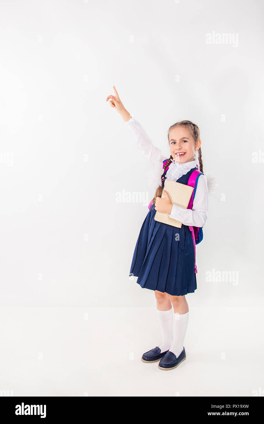 Cute schoolgirl with notebooks and books on a white background ...