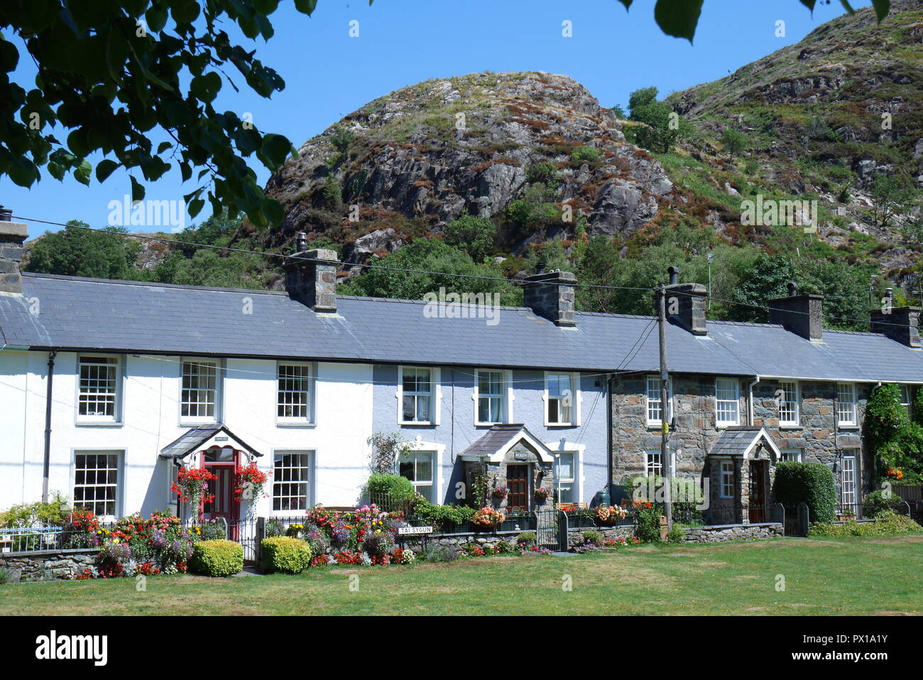 Row of terraced cottages, looking onto the village green, Beddgelert, Gwynedd, Snowdonia, North Wales, United Kingdom Stock Photo