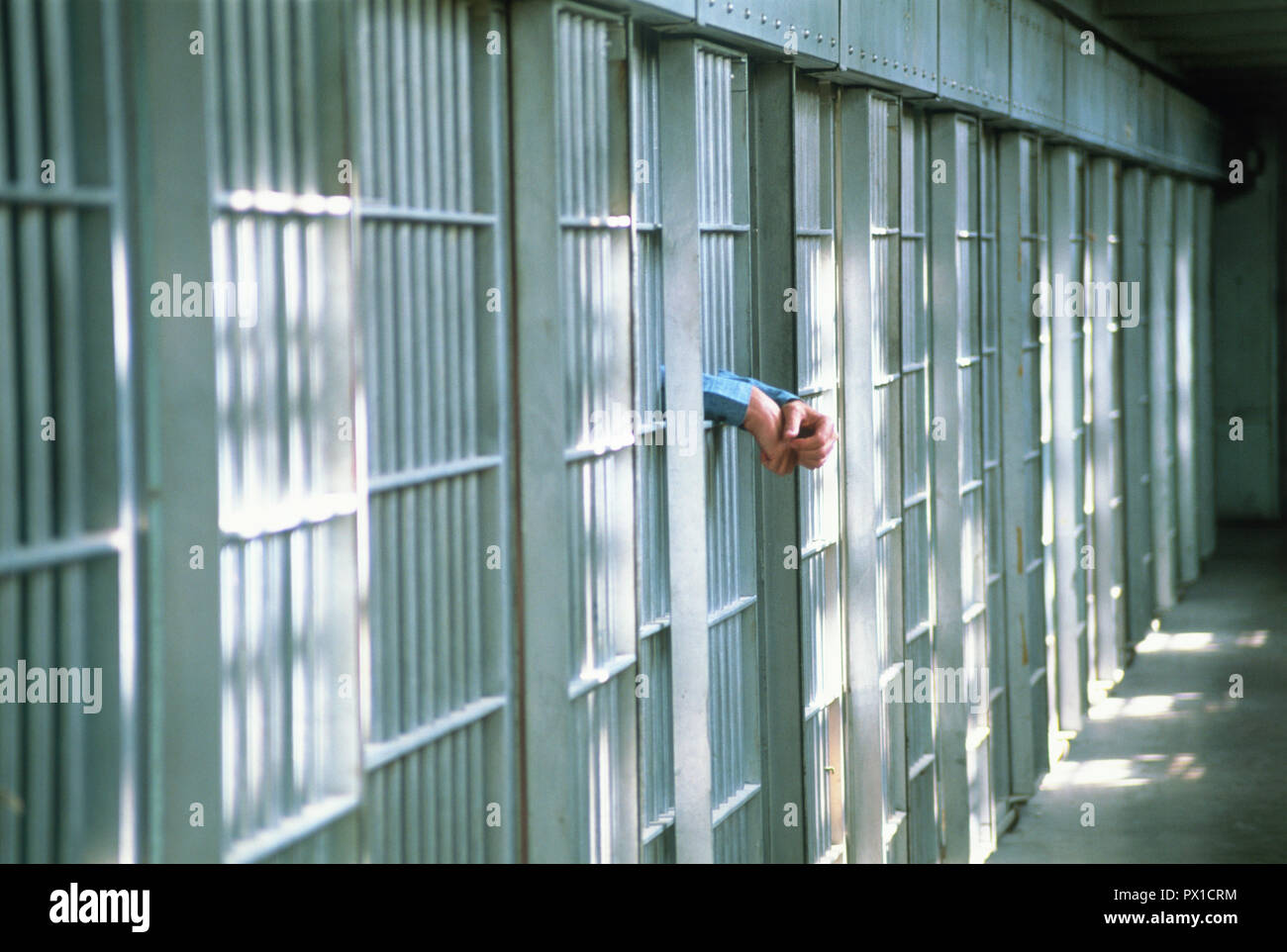 Single prisoner in a penitentiary cell block, USA Stock Photo