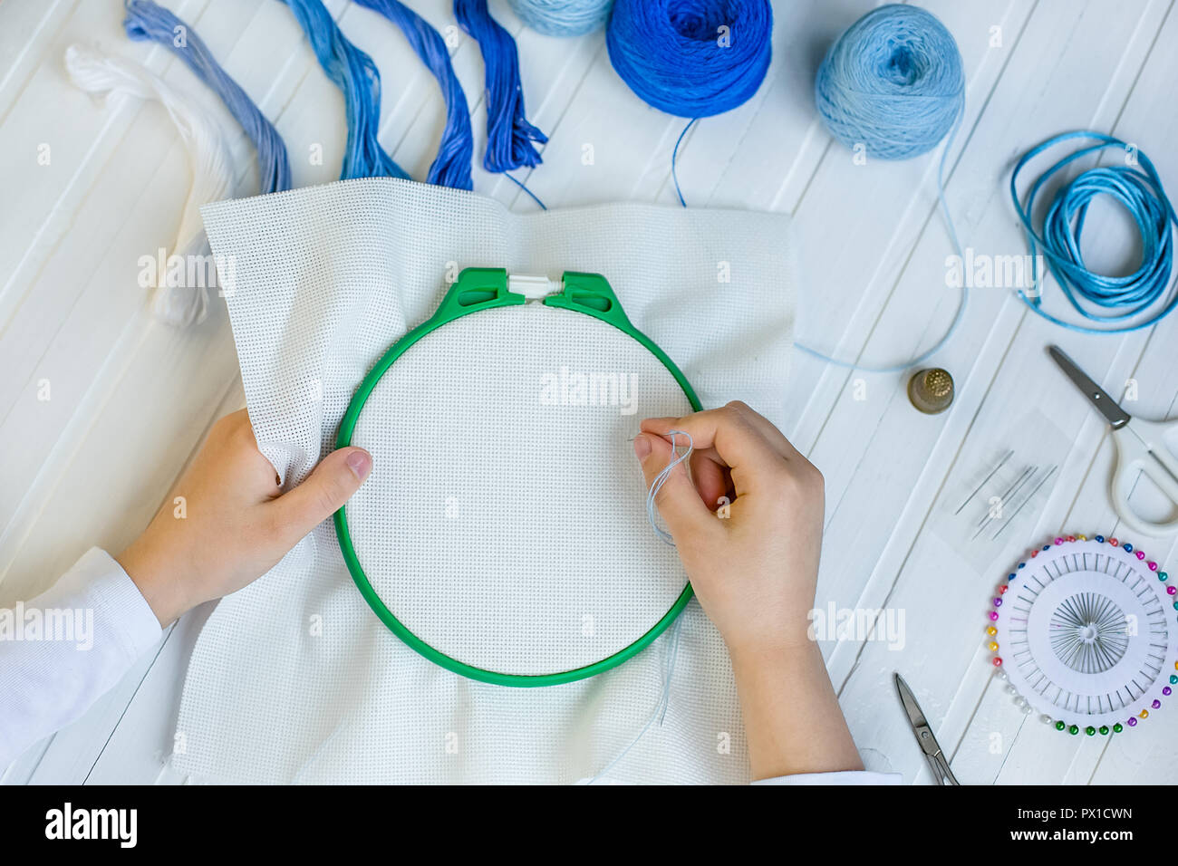Embroidery hoop with fabric, sewing needles and thread, closeup Stock Photo  - Alamy