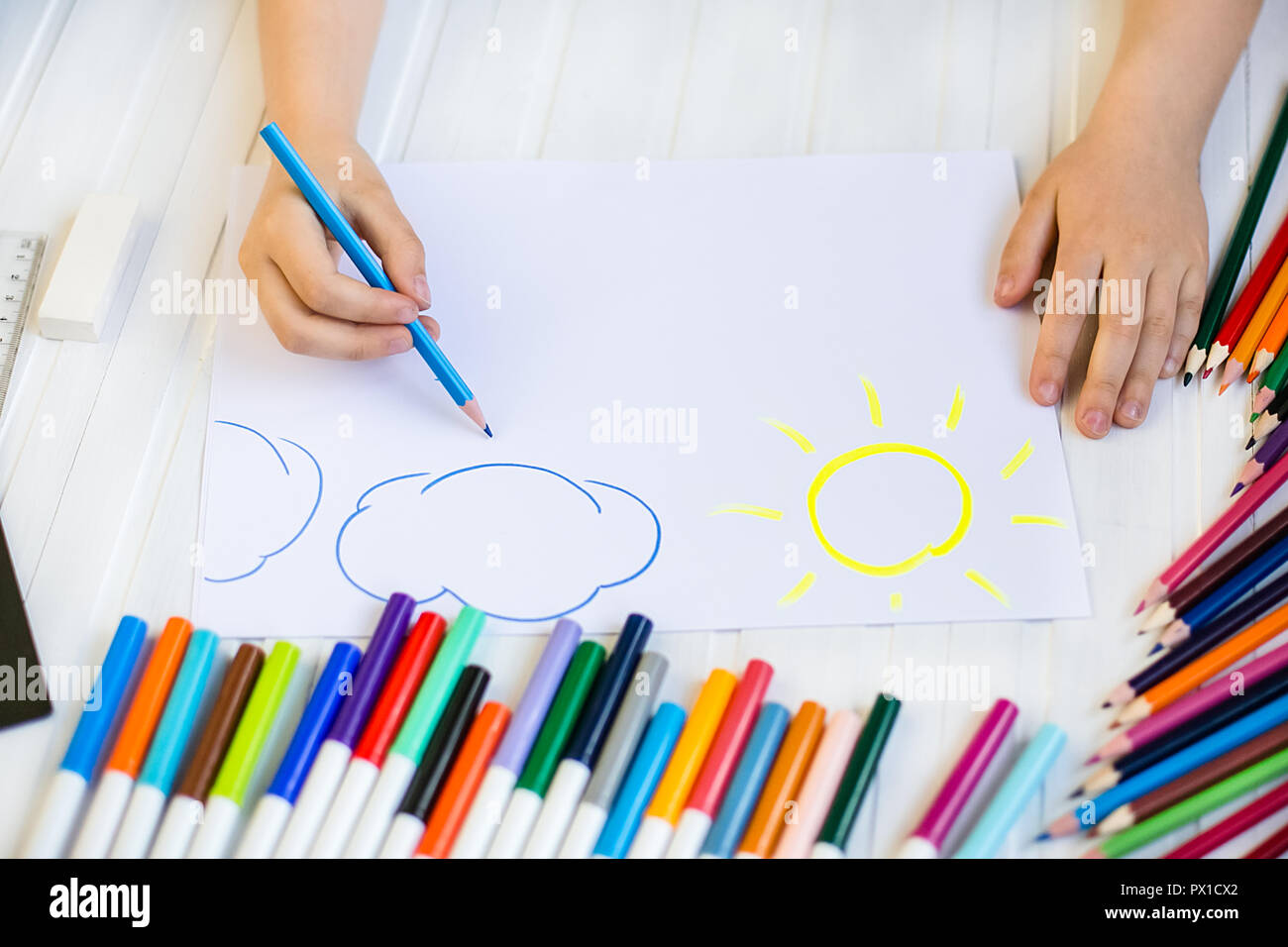 Kids drawing on white sheet of paper background Stock Photo - Alamy
