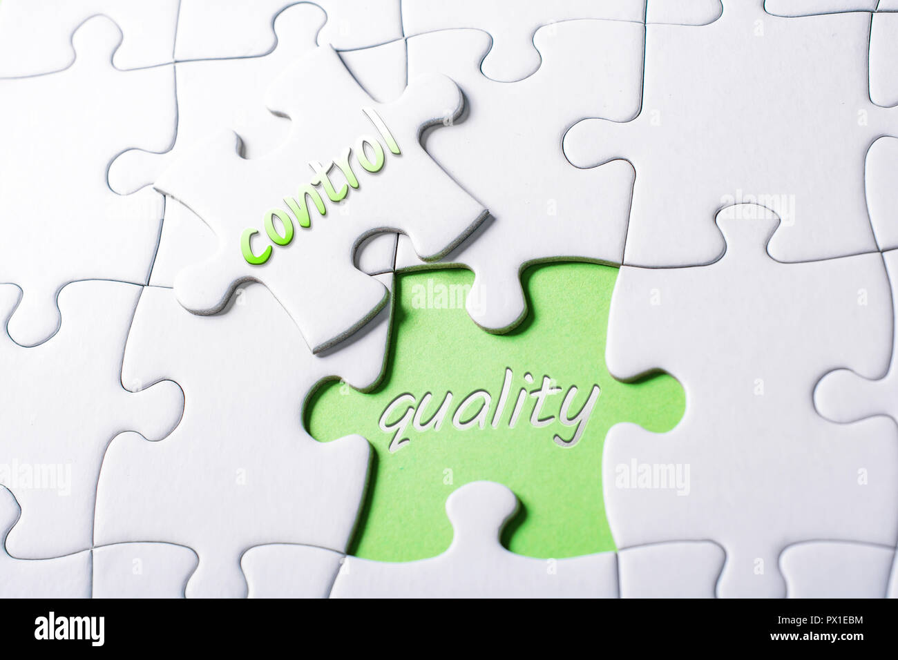 The Words Quality And Control In Missing Piece Jigsaw Puzzle Stock