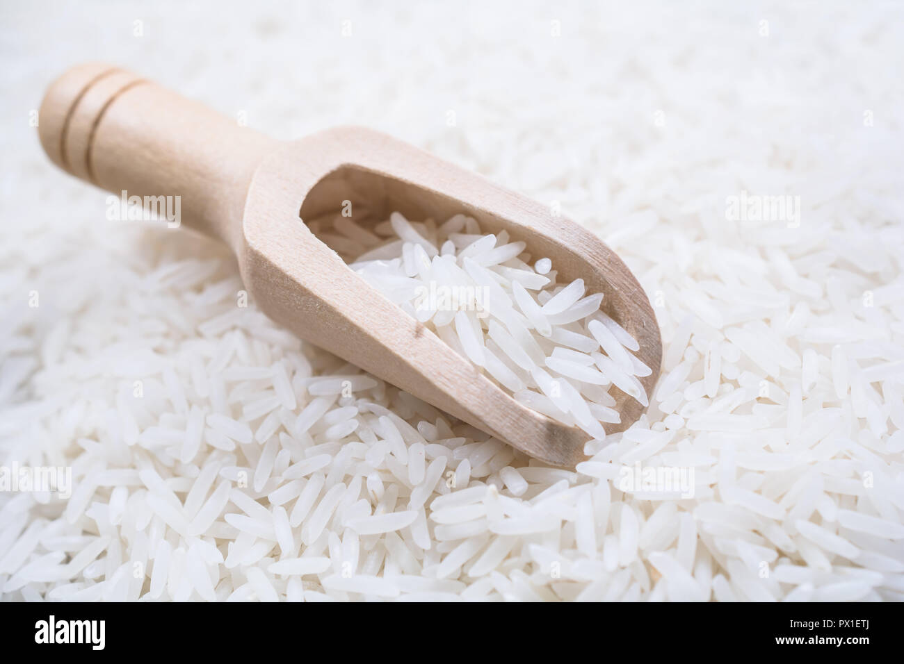 A Wooden Kitchen Scoop On A Pile Of Rice Stock Photo