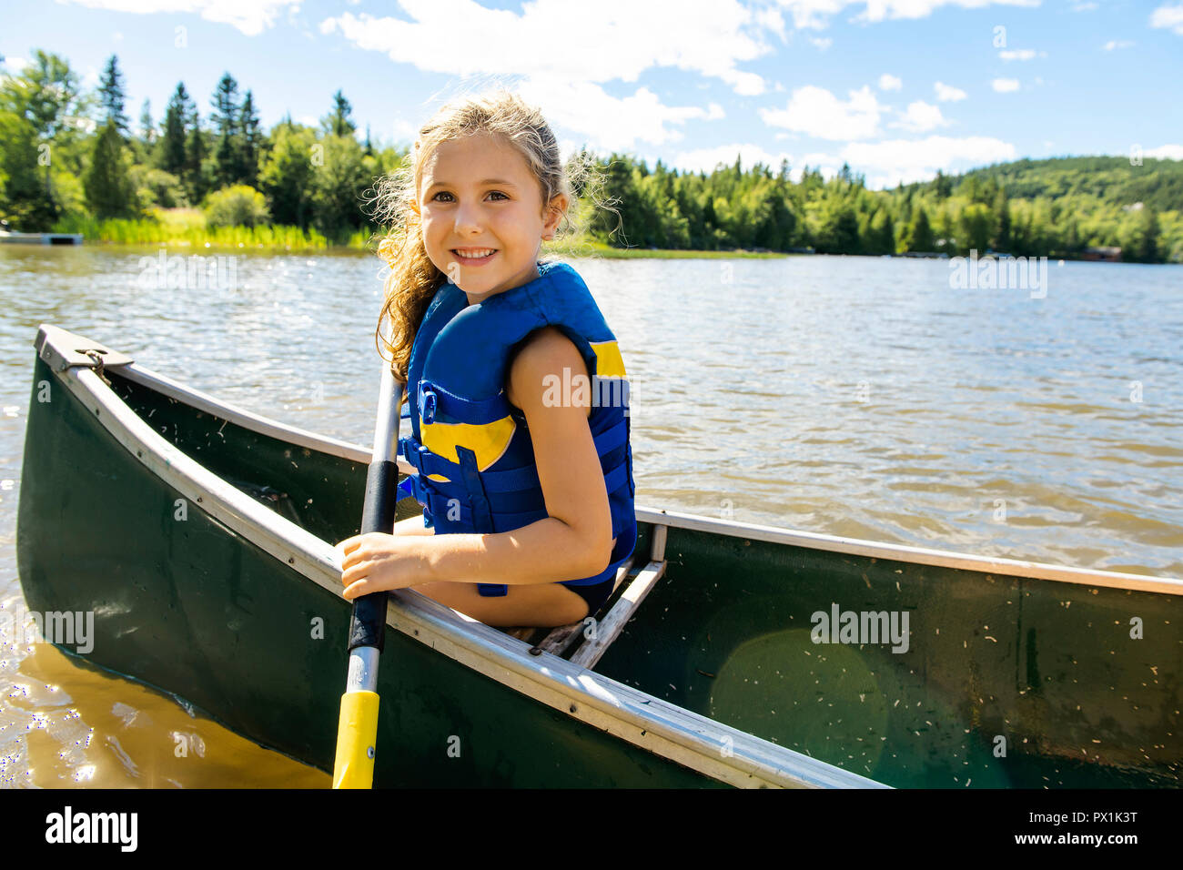 Happy kid enjoying canoe ride on beautiful river Stock Photo Alamy