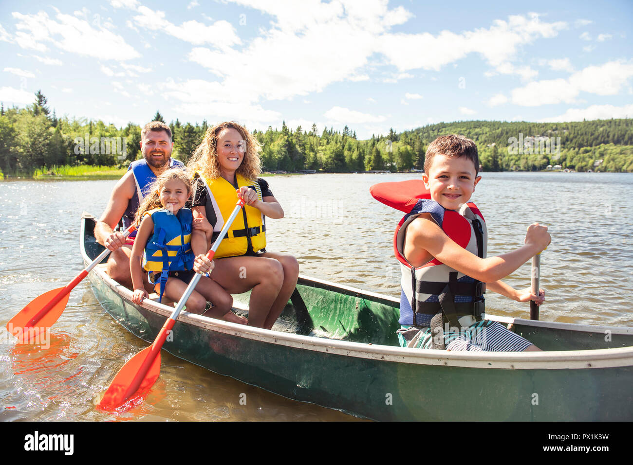 Family in a Canoe on a Lake having fun Stock Photo - Alamy