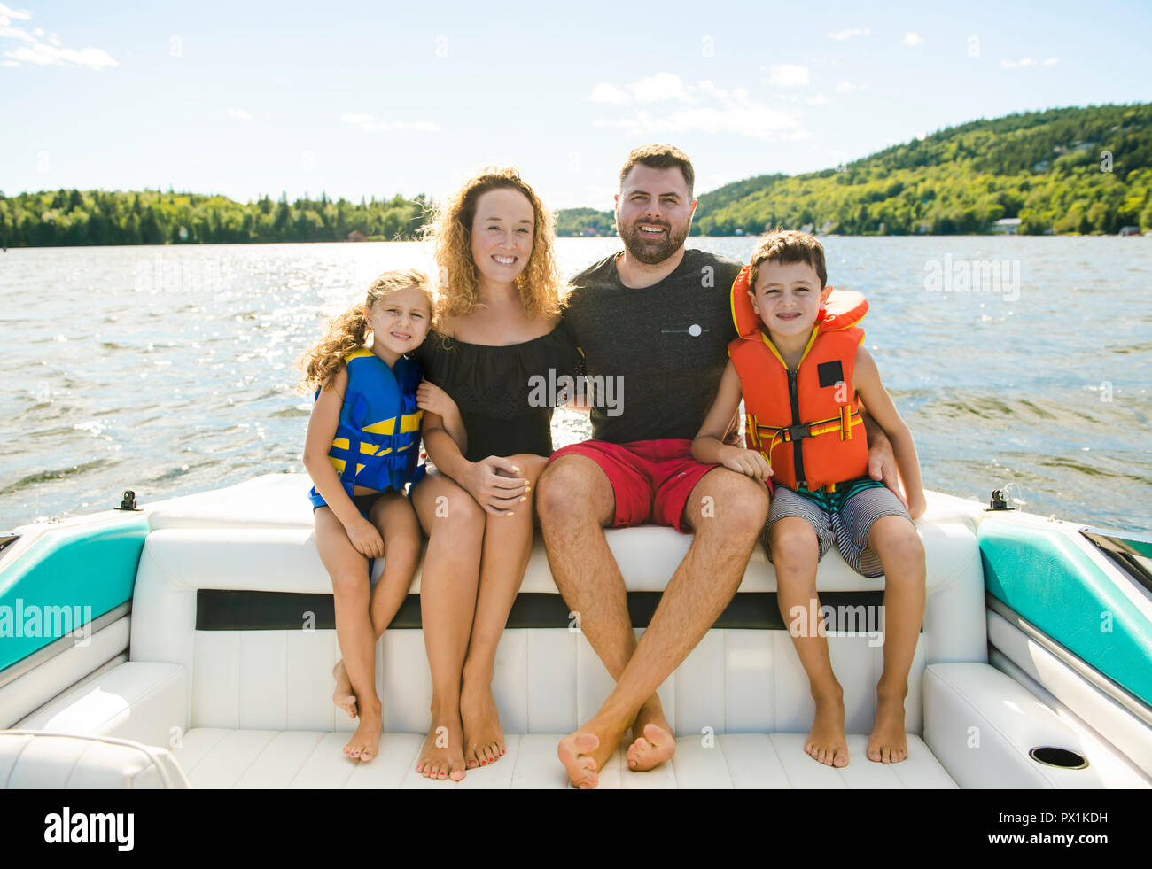 Family out boating together having fun on vacancy Stock Photo