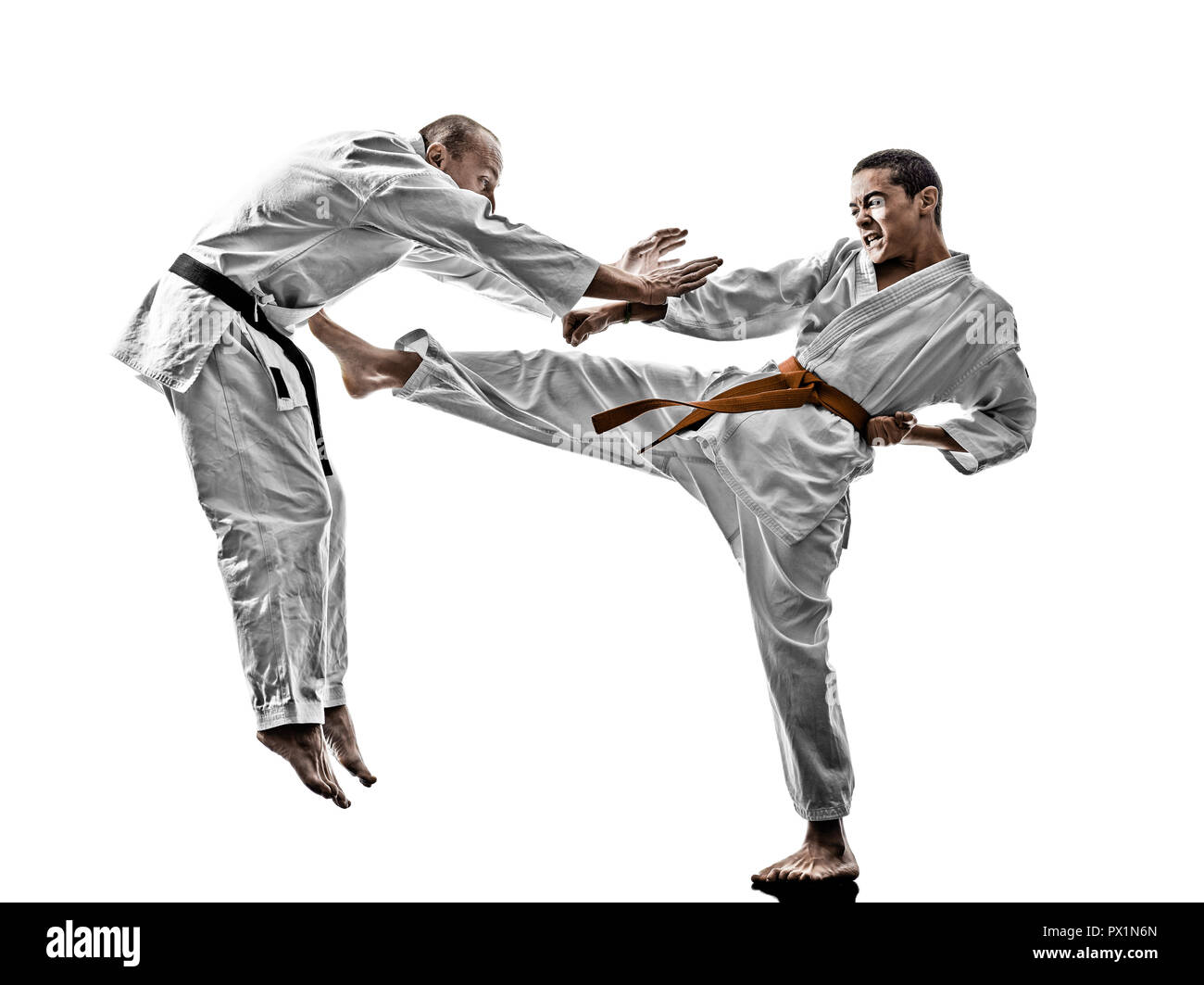 two karate men sensei and teenager student fighters fighting isolated on white background Stock Photo