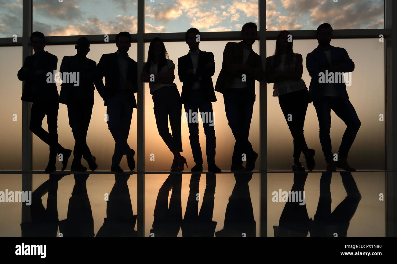 silhouette of a business team standing next to the office window Stock ...