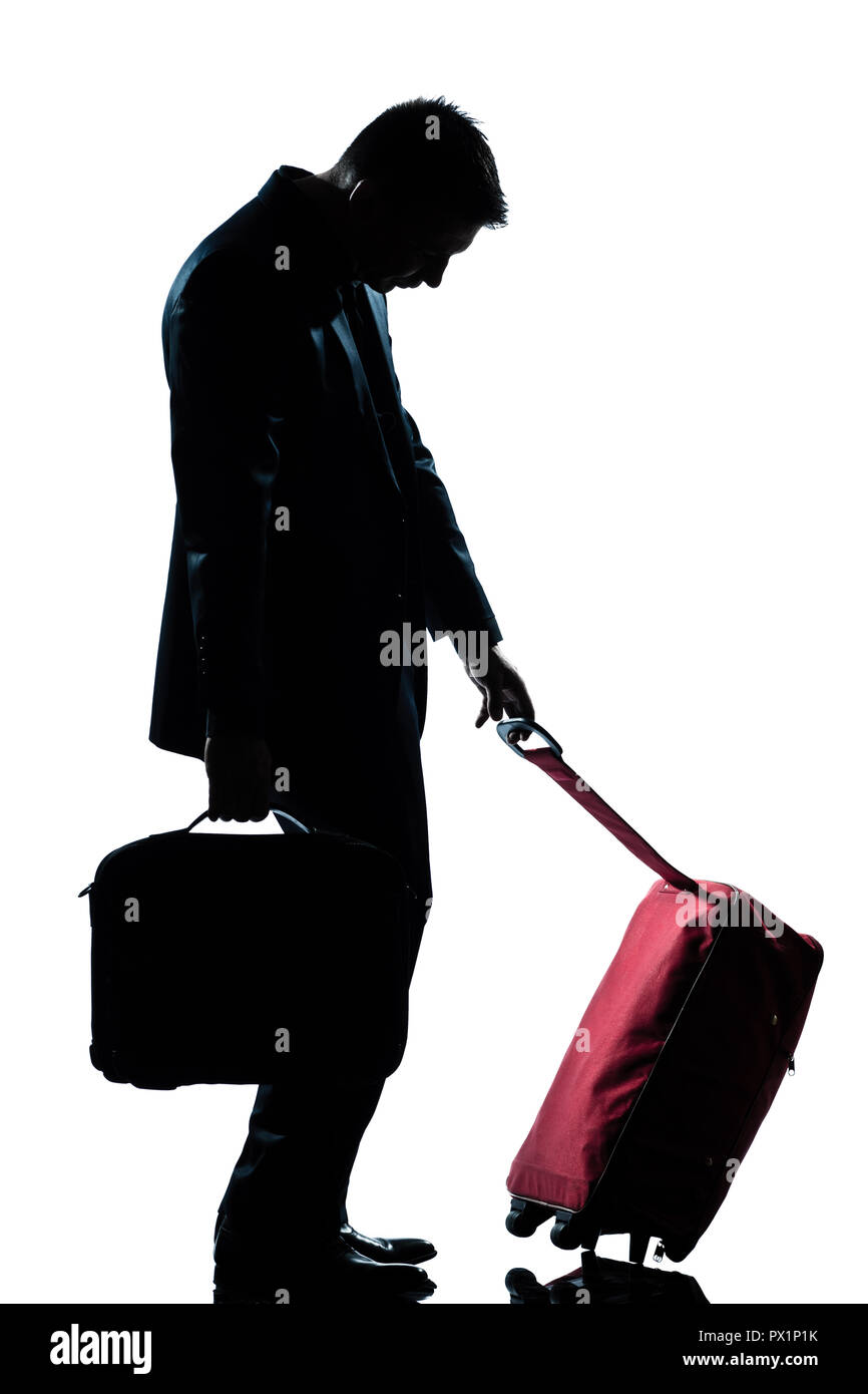 side view one caucasian business traveler man tired with suitcase  full length silhouette in studio isolated white background Stock Photo