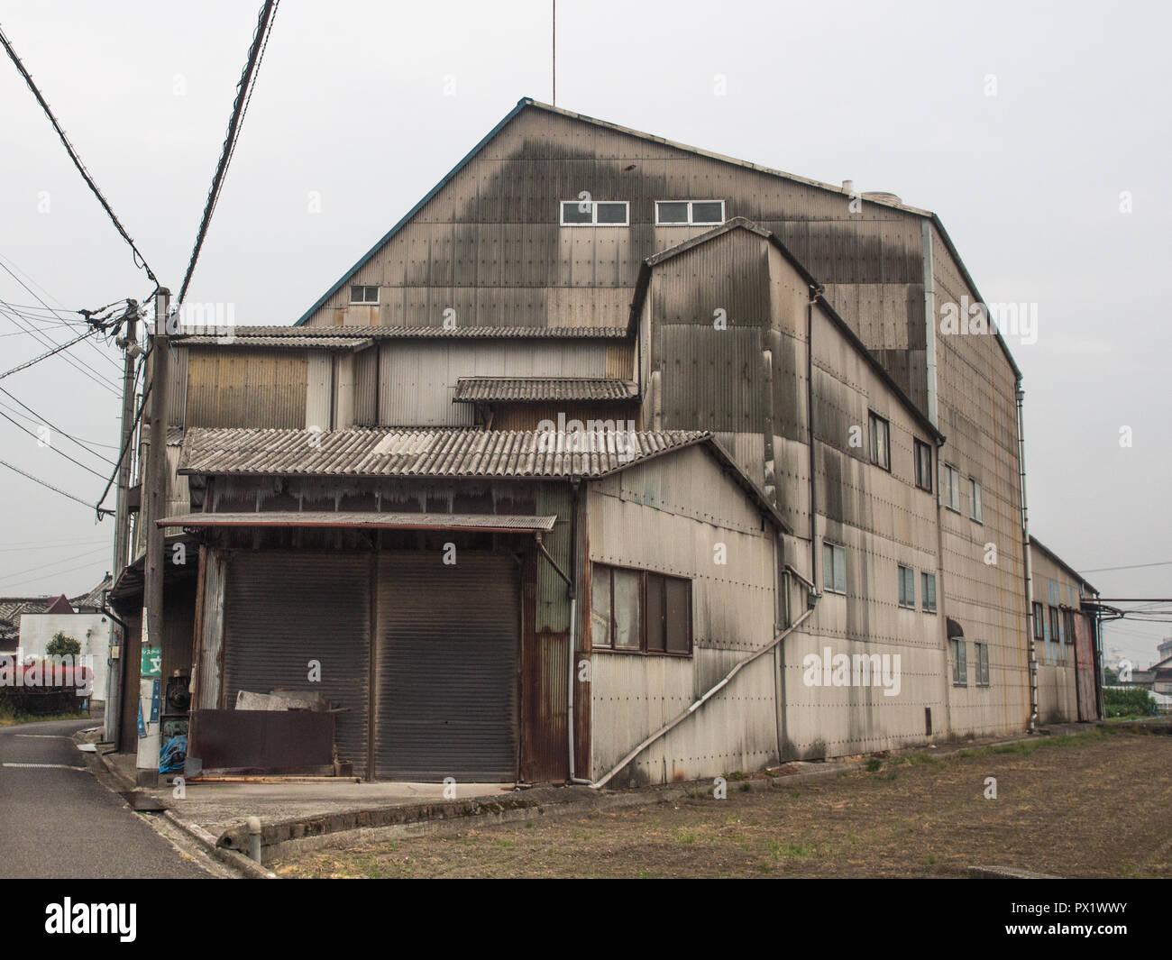 Industrial building, modernist architecture, corrugated iron, urban street, Saijo, Ehime, Japan Stock Photo