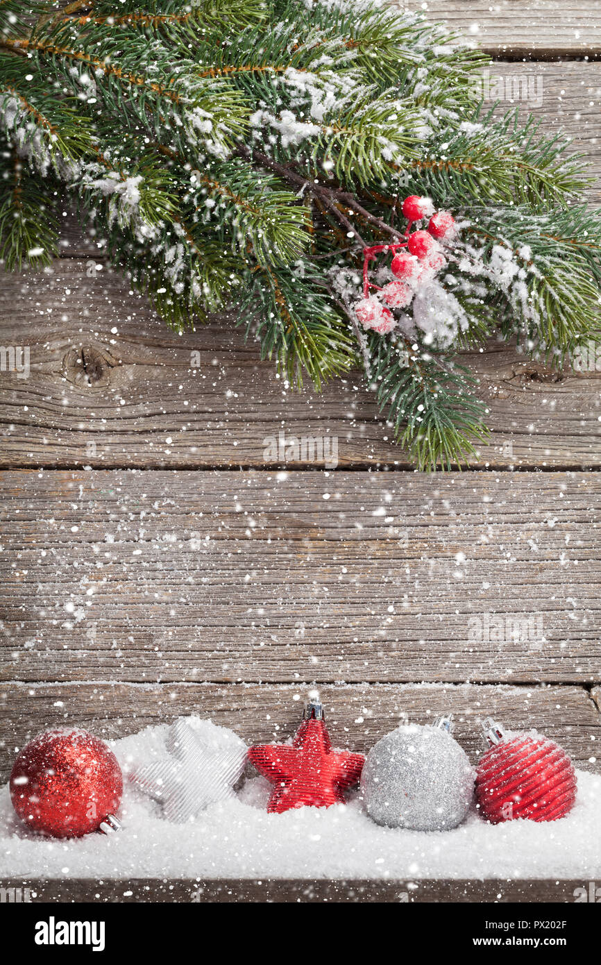 Christmas backdrop with fir tree branch covered by snow and decor ...