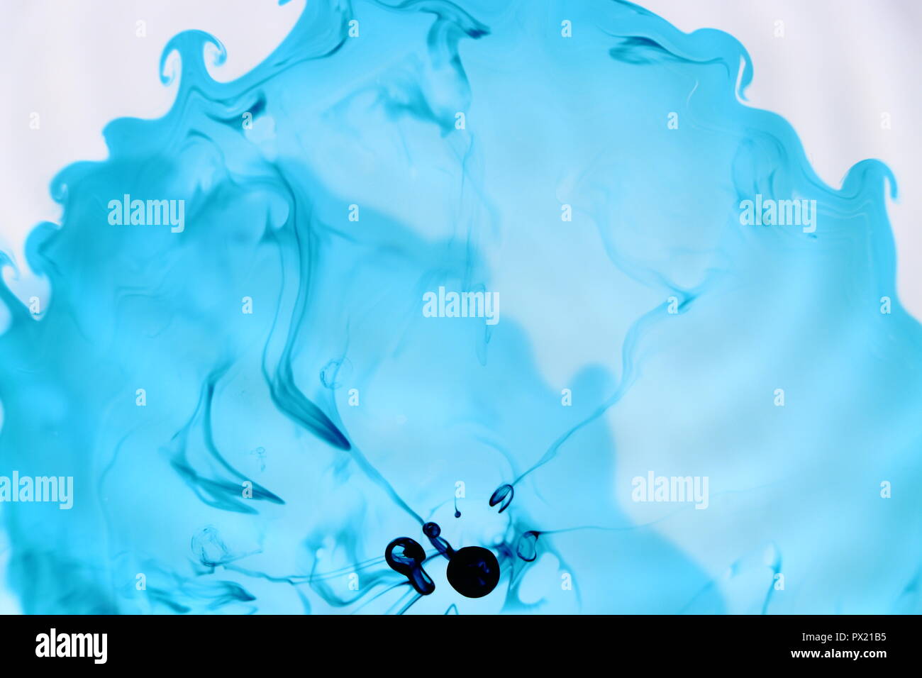 Naturally Flowing Blue Food Dye in Water Stock Photo