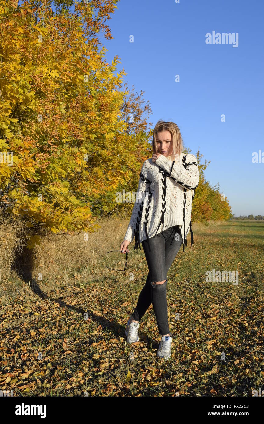 Girl on a background of yellow leaves of autumn trees. Autumn photo ...