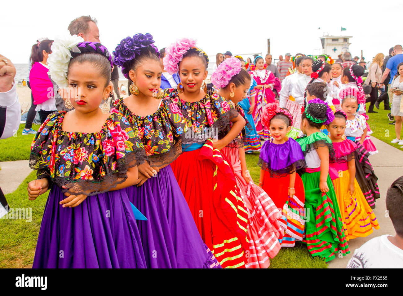 Young Mexican American Folklorico dancers dancer line up for the children's parade at an outdoor