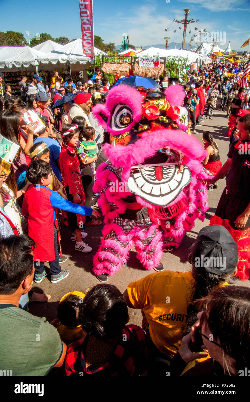 A fuzzy pink pantomime lion draws a crowd at an Asian American cultural festival in Costa Mesa, CA. Stock Photo