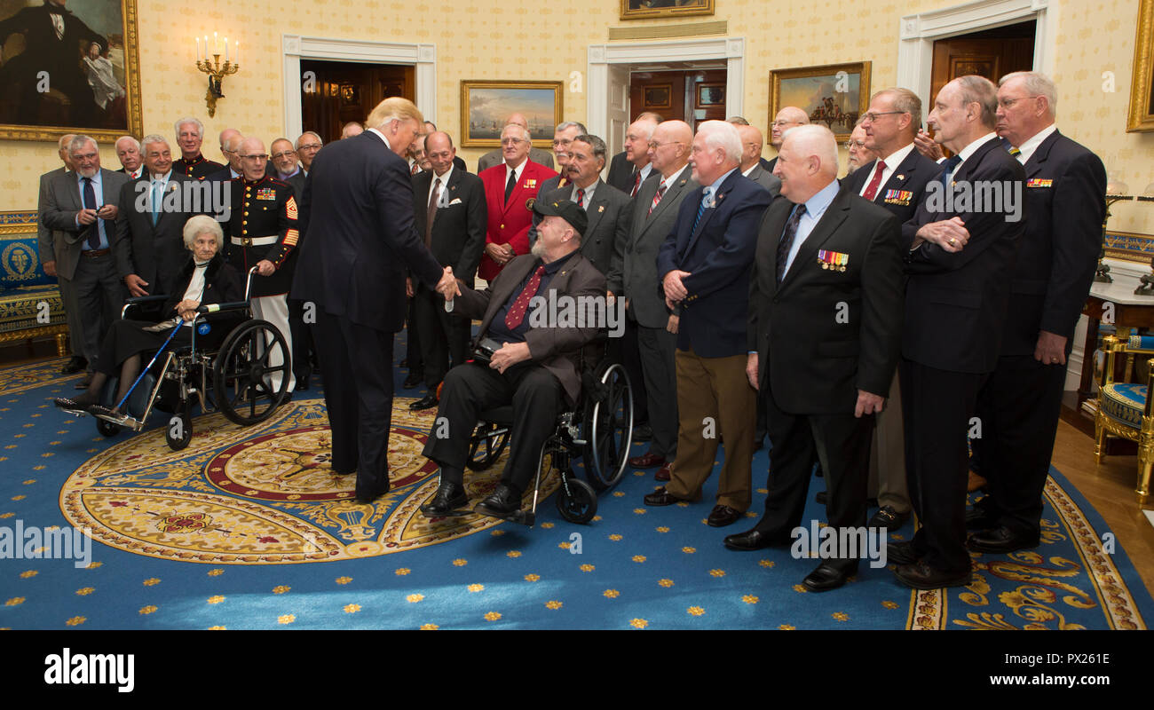 President of the United States Donald J. Trump shakes hands with Vietnam veterans before the official Medal of Honor ceremony of retired U.S. Marine Corps Sgt. Maj. John L. Canley, the 300th Marine Medal of Honor recipient, at the White House in Washington, D.C., Oct. 17, 2018. From Jan. 31, to Feb. 6 1968 in the Republic of Vietnam, Canley, the company gunnery sergeant assigned to Alpha Company, 1st Battalion, 1st Marines, took command of the company, led multiple attacks against enemy-fortified positions, rushed across fire-swept terrain despite his own wounds and carried wounded Marines int Stock Photo