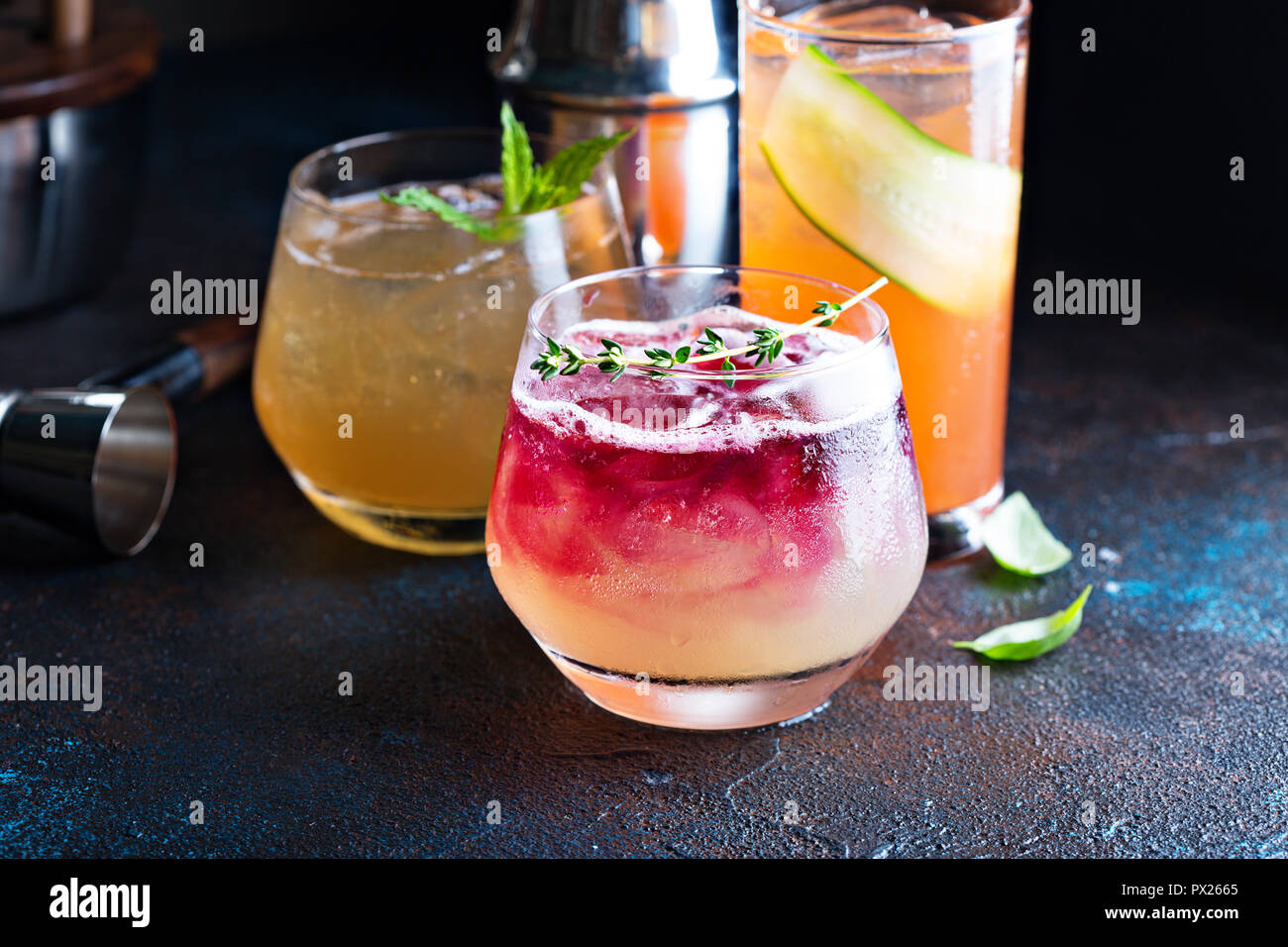 Variety of seasonal fall cocktails with citrus, apple cider, pomegranate syrup, whiskey and gin Stock Photo