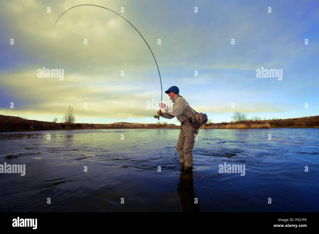 Fly fishing for trout with fly rod and reel Stock Photo