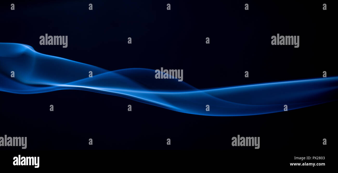 Abstract blue smoke swirls on dark background Stock Photo - Alamy