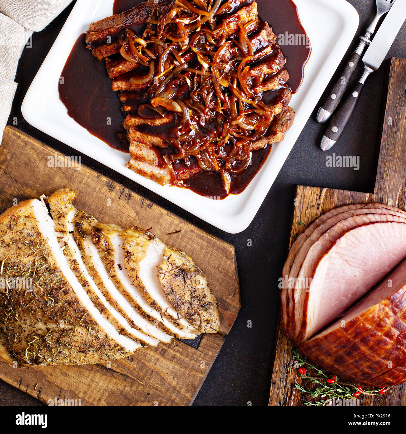 Holiday meats shot from above with roasted turkey, sliced ham and