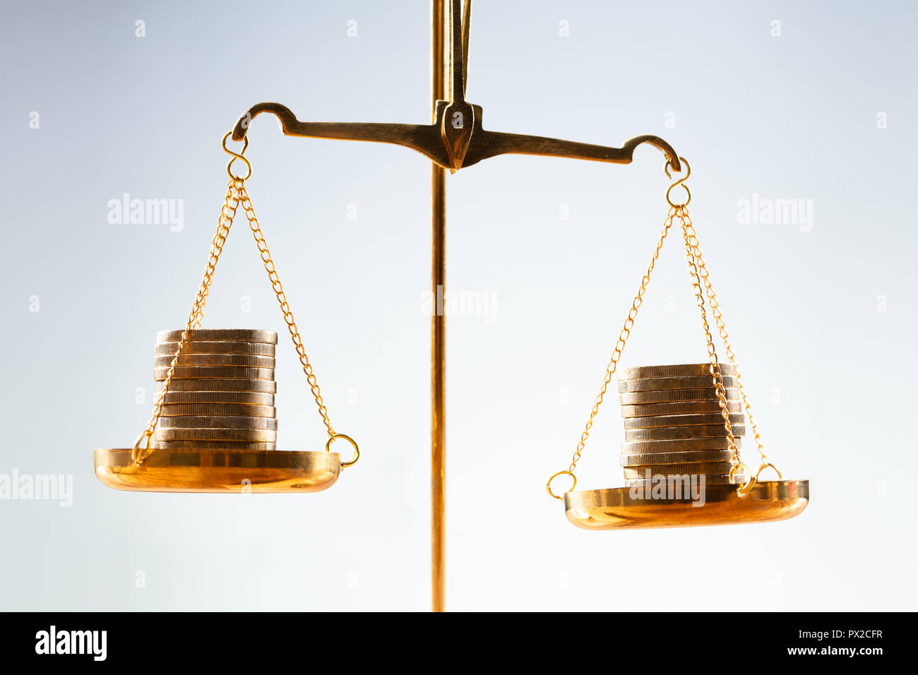 Close-up Of Golden Stacked Coins On Justice Scale Stock Photo - Alamy