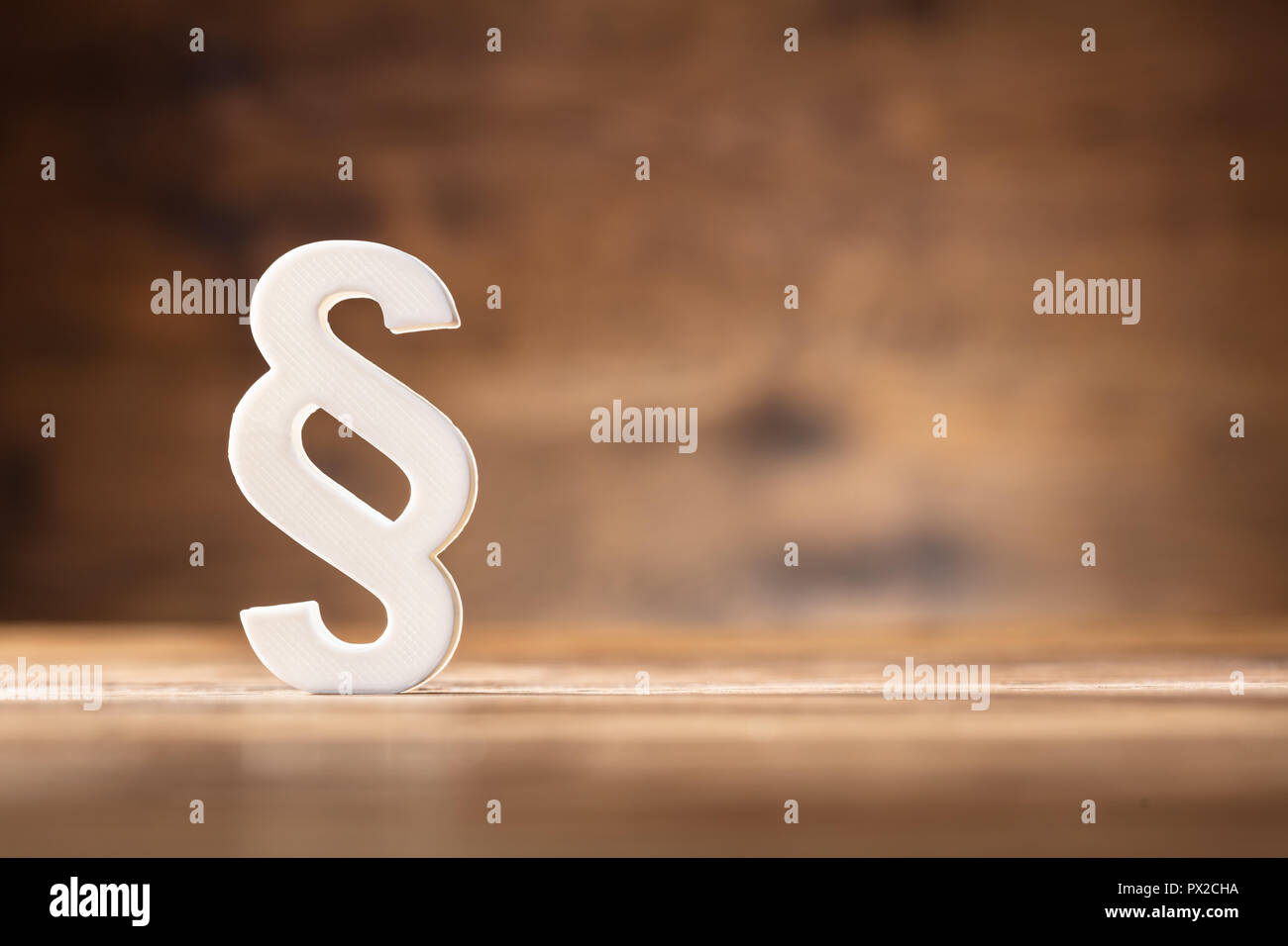 Close-up Of A White Paragraph Symbol On Wooden Desk Stock Photo