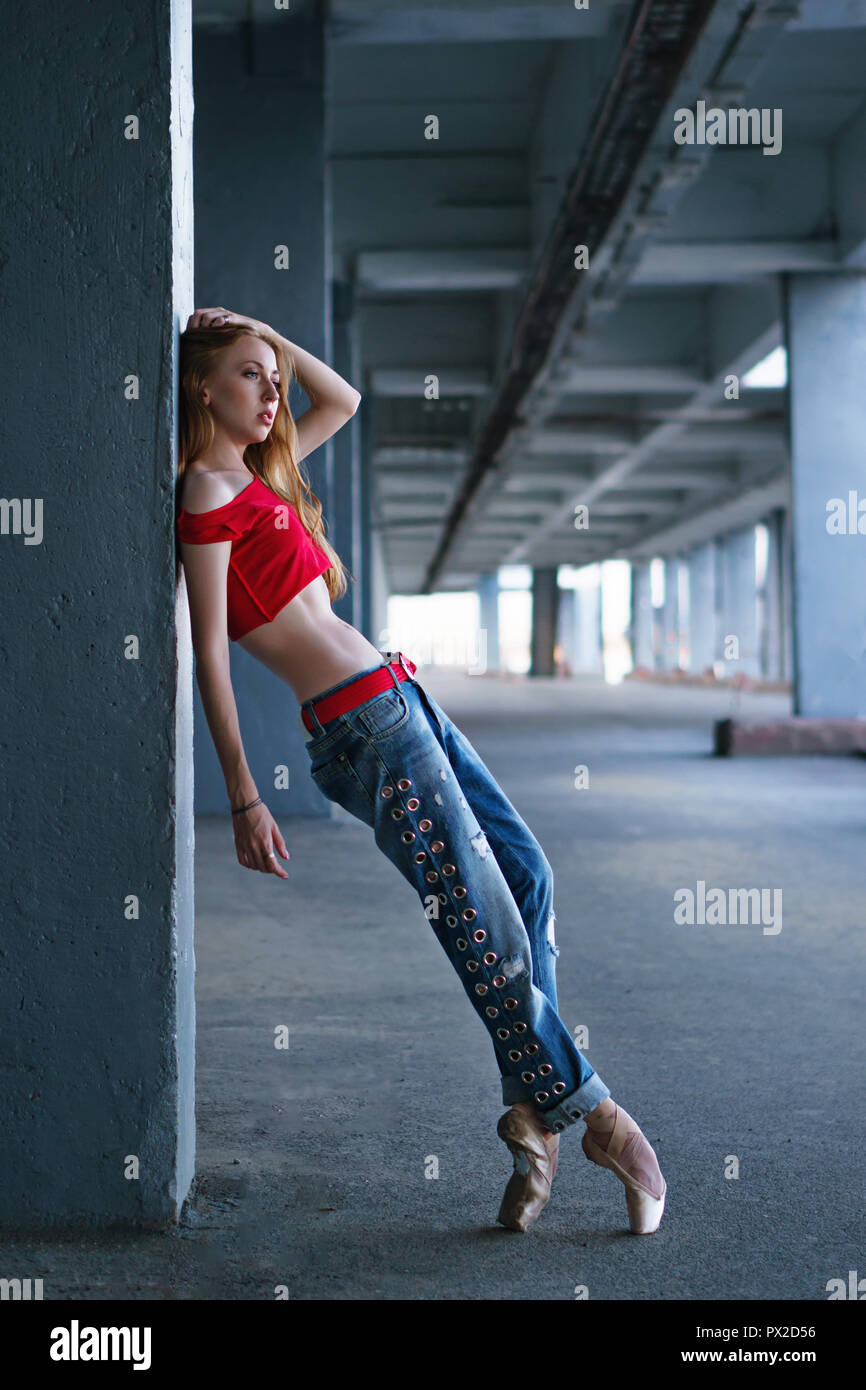 Ballerina dancing in jeans, t-shirt and pointe. Street performance. Modern  ballet. Slim girl dancing on tiptoe. Desire art Stock Photo - Alamy