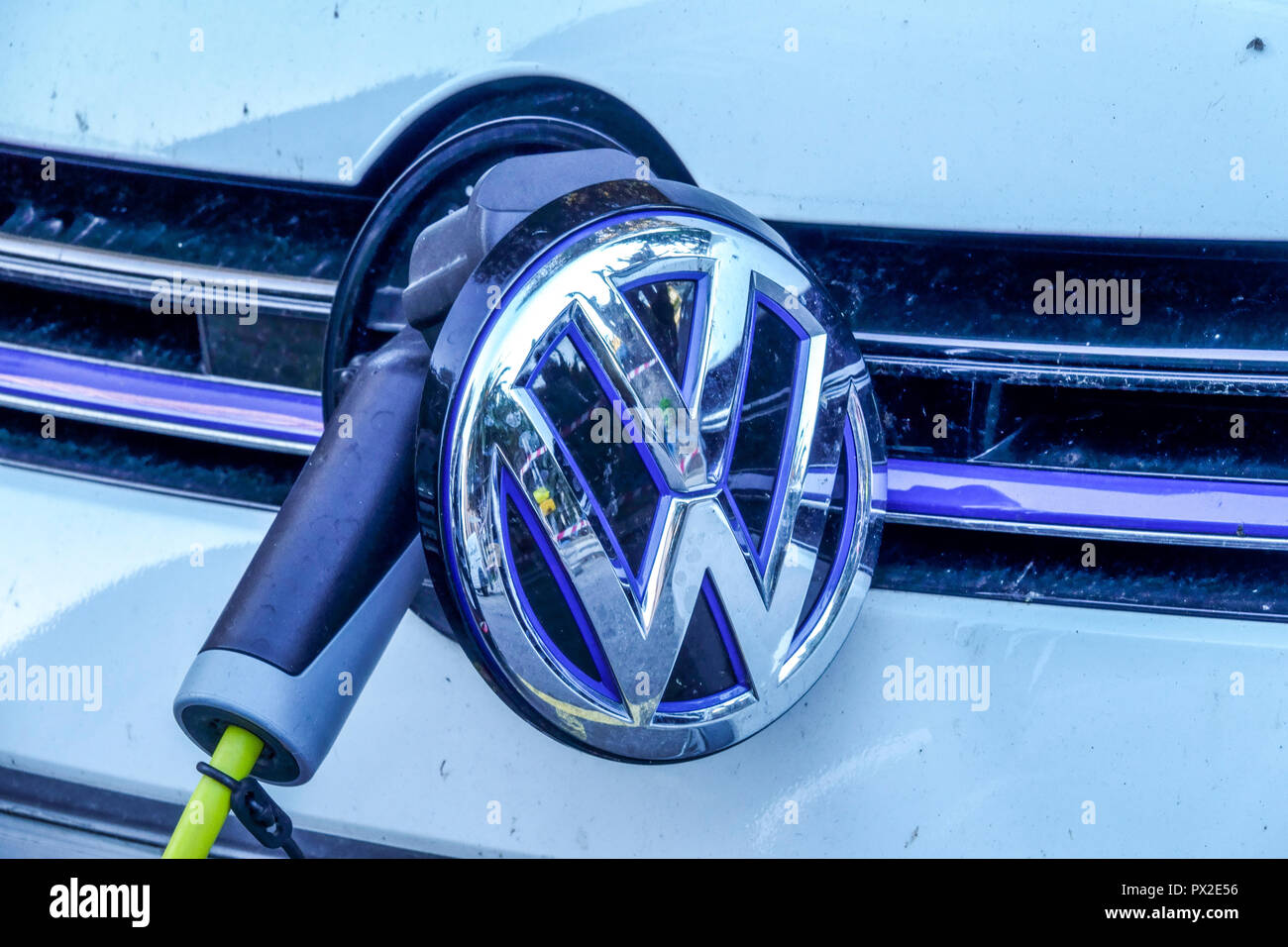 VW car charging electric car charger, supply plugged VW electric Stock Photo