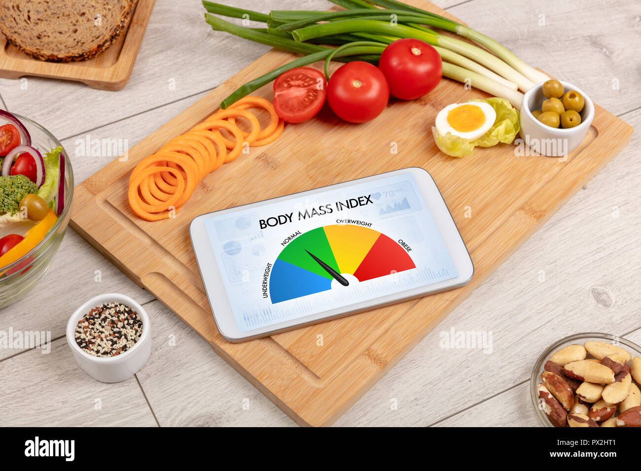 Healthy food with tablet on a wooden background with words Body Mass