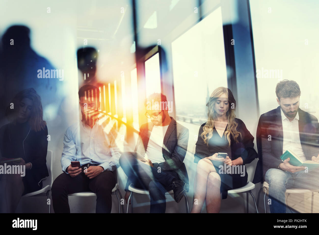 Young candidates waiting for an interview for a job. Concept of recruitment ad career. Double exposure effects with a glass window Stock Photo