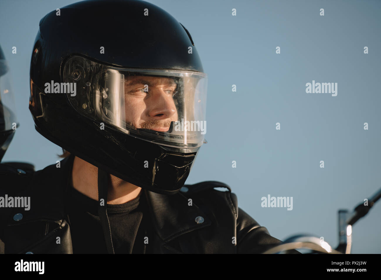 portrait of man in motorcycle helmet looking away Stock Photo - Alamy