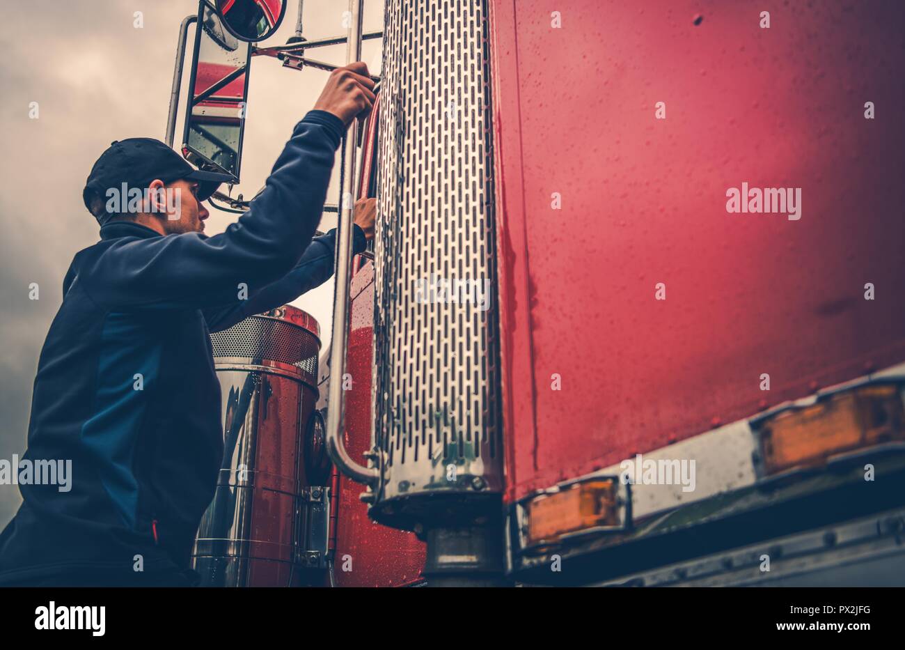 Transportation Industry Theme. Truck Driver Getting Into Truck Time To Hit the Road with Heavy Load. Stock Photo