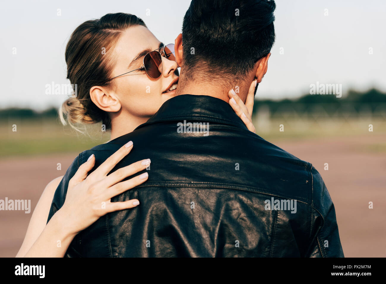 selective focus of beautiful smiling woman embracing boyfriend in ...