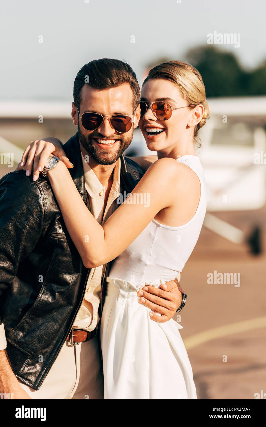 laughing attractive woman hugging stylish boyfriend in leather jacket ...