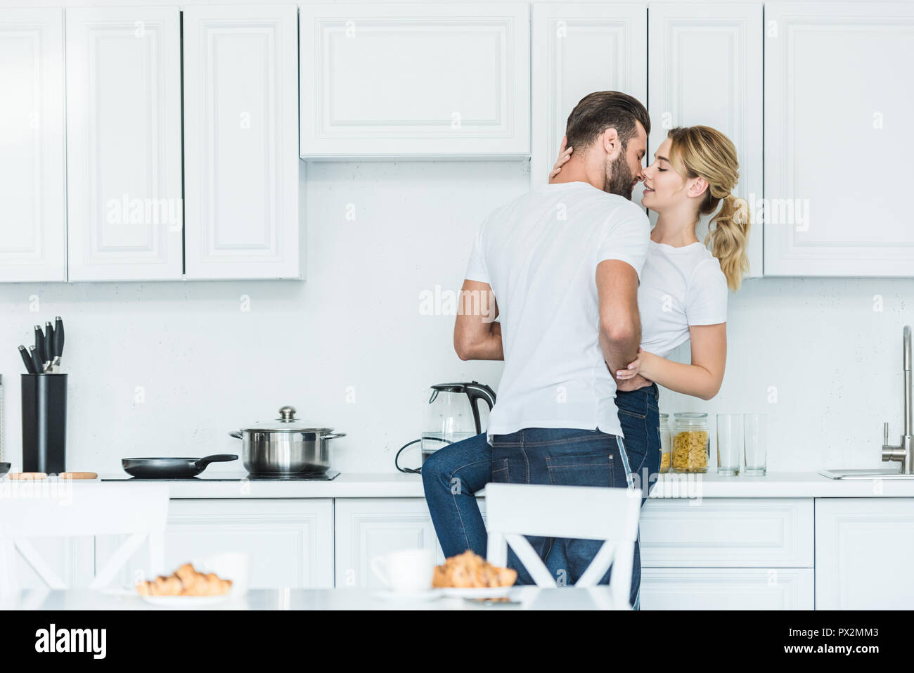Beautiful Young Couple In Love Kissing In Kitchen At Morning Stock Photo Alamy