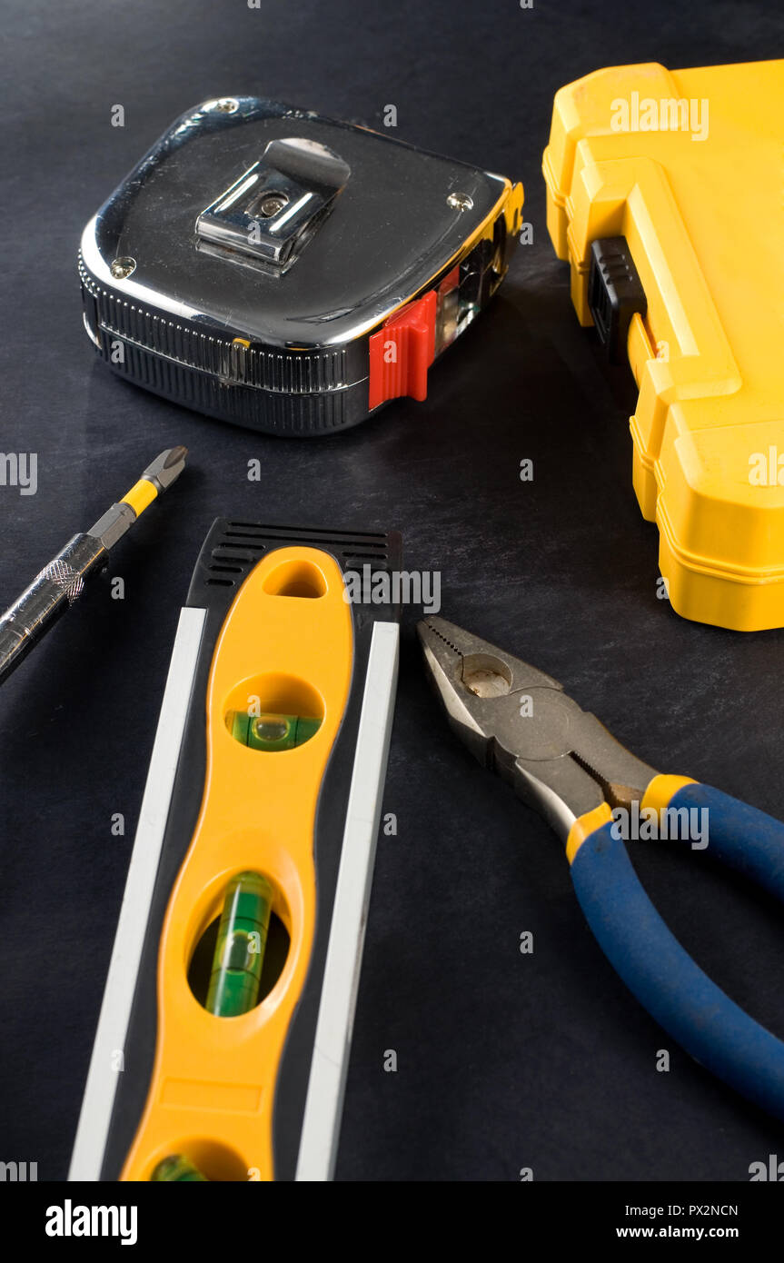 Yellow Tool Box and Tools on Dark Background Vertical Stock Photo