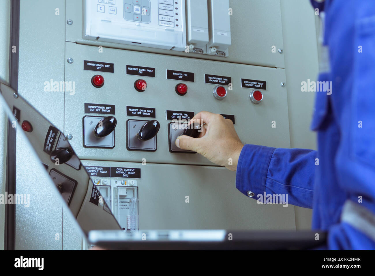 Male engineers are checking the electrical system by program in laptop. Stock Photo