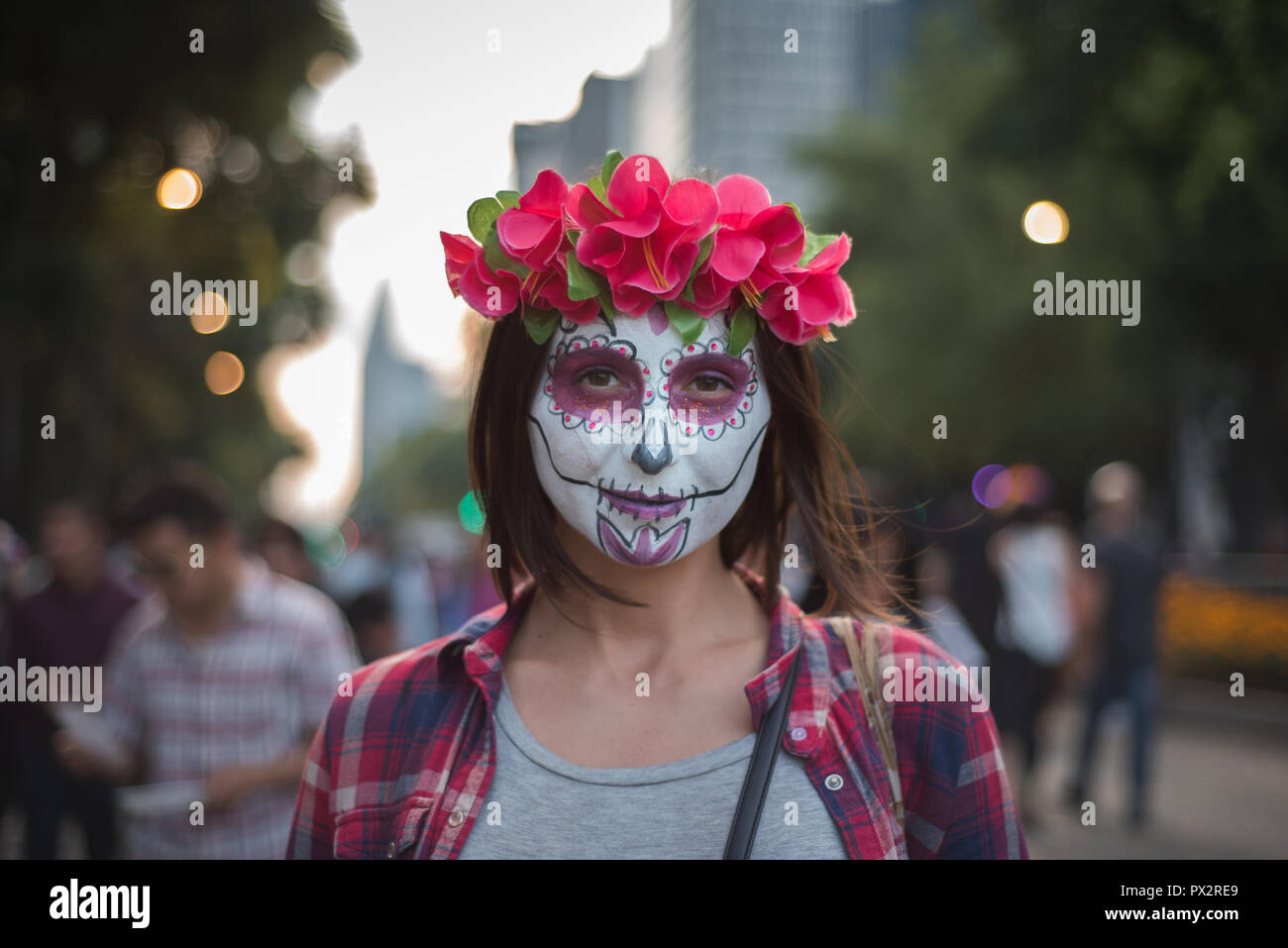 A young woman wearing typical 'catrina' makeup at the Day of the Dead parade in Mexico City Stock Photo